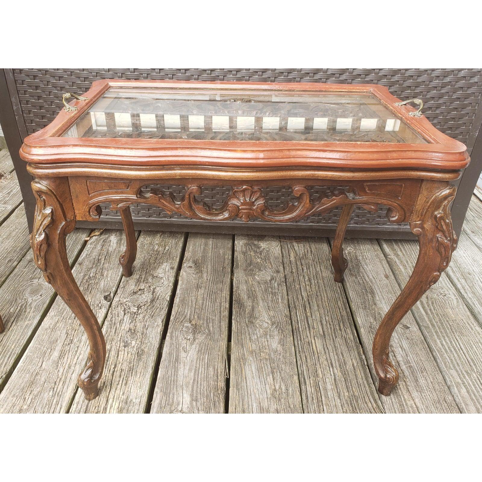 Rare antique intricately hand carved solid walnut tray table. Glass tray comes loose. Brass tray handles.