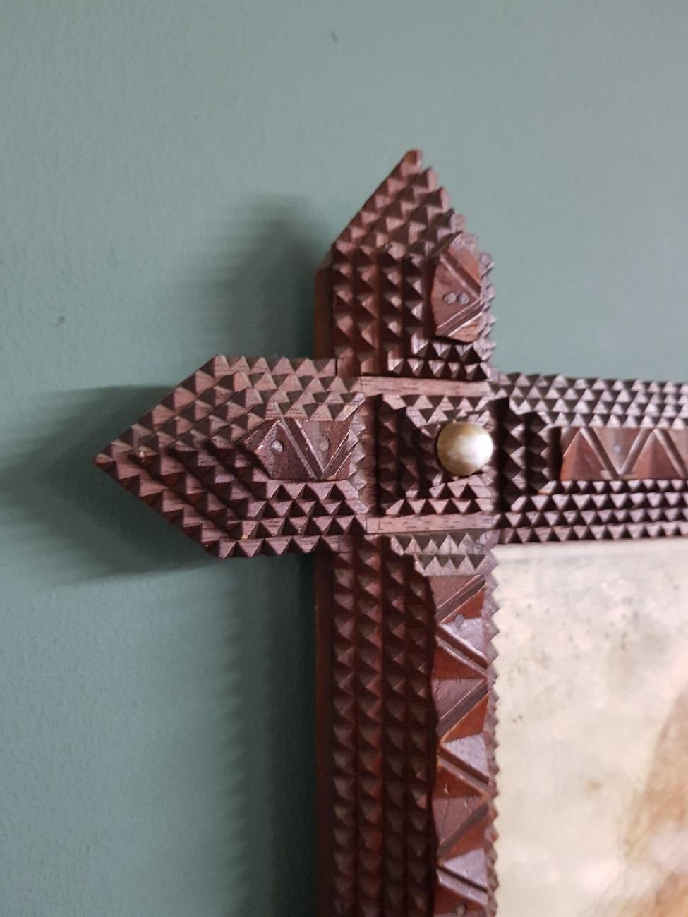 Hand carved wooden Tramp Art picture frame from circa 1900, probably of American origin.

The measurements are,
Depth 3.5 cm/ 1.3 inch.
Width 39 cm/ 15.3 inch.
Height 45 cm/ 17.7 inch.