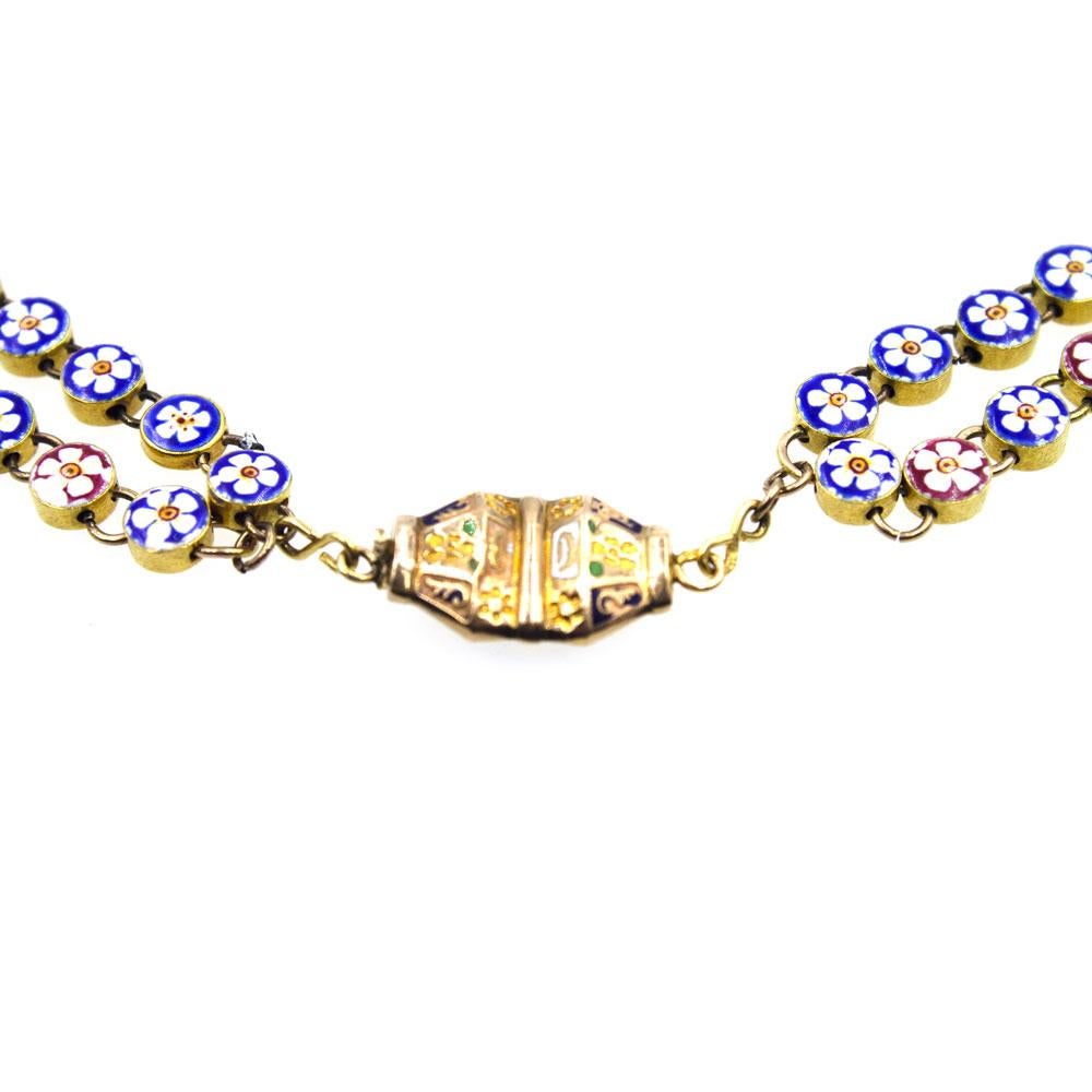 This stunning antique necklace with Russian hallmarks is handcrafted in 20 karat yellow gold round links. Each link is hand enameled with a floral design. The enamel flower links are blue and red with variations of white and yellow flowers. There