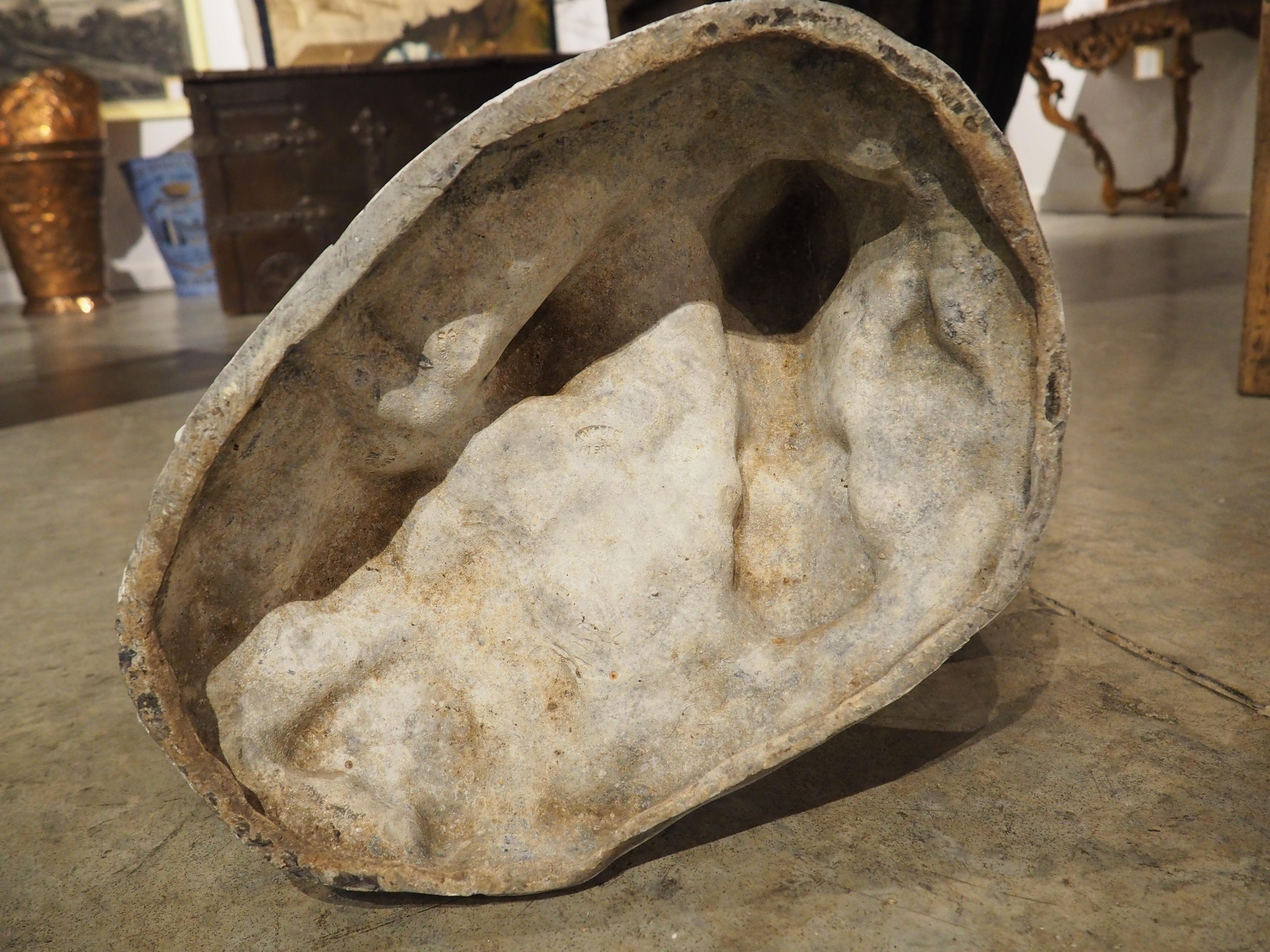 This heavy lead sculpture of a rooster with a whitewashed finish was produced in France in the early 1900’s. Our proud rooster can be seen strutting across a rocky foundation. The ground is covered with a fruited flower and two bound sheaves of