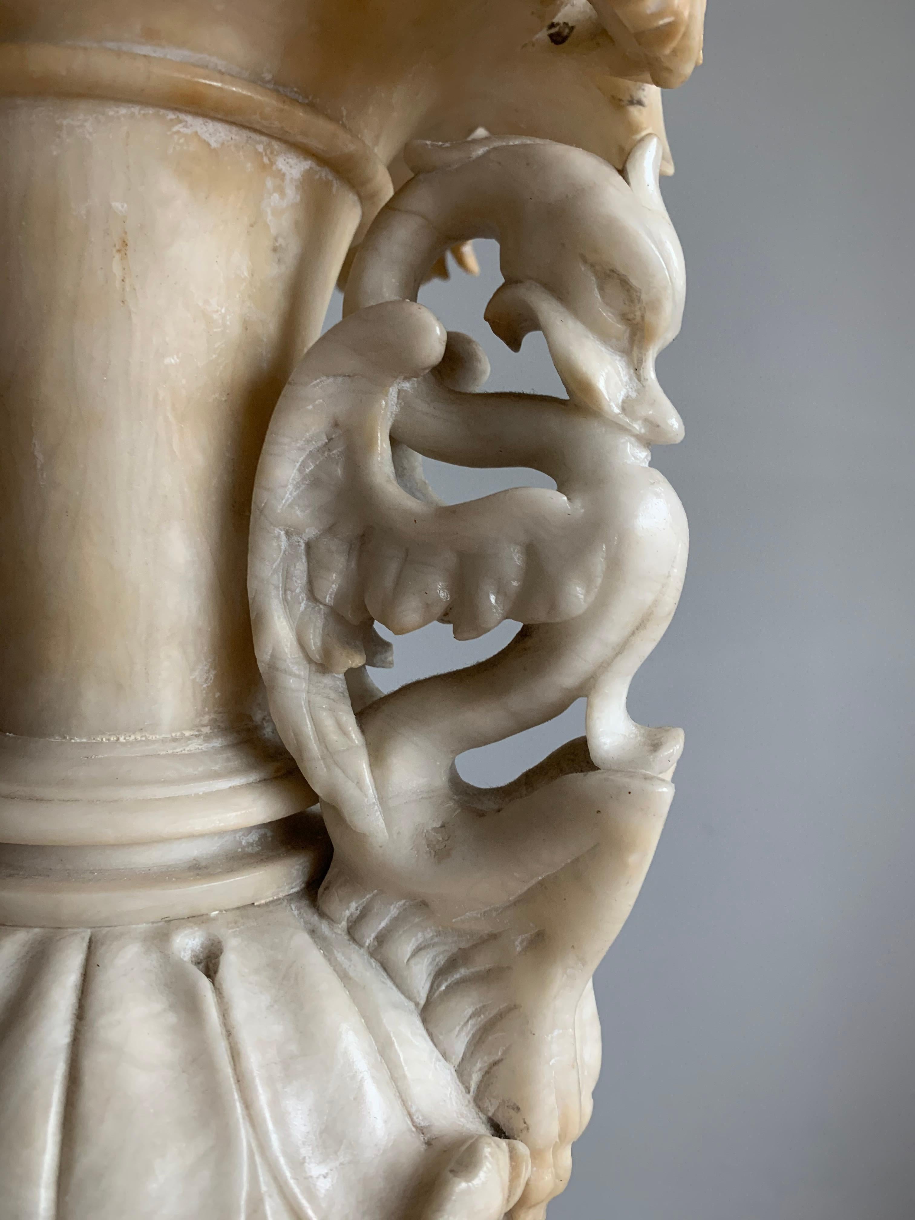 Rare and impressive work of sculptural art.

Have you ever tried to hand carve a figure out of a piece of natural mineral stone? Only than you can really come close to having an idea of how remarkable this vase is. To be able to hand carve these