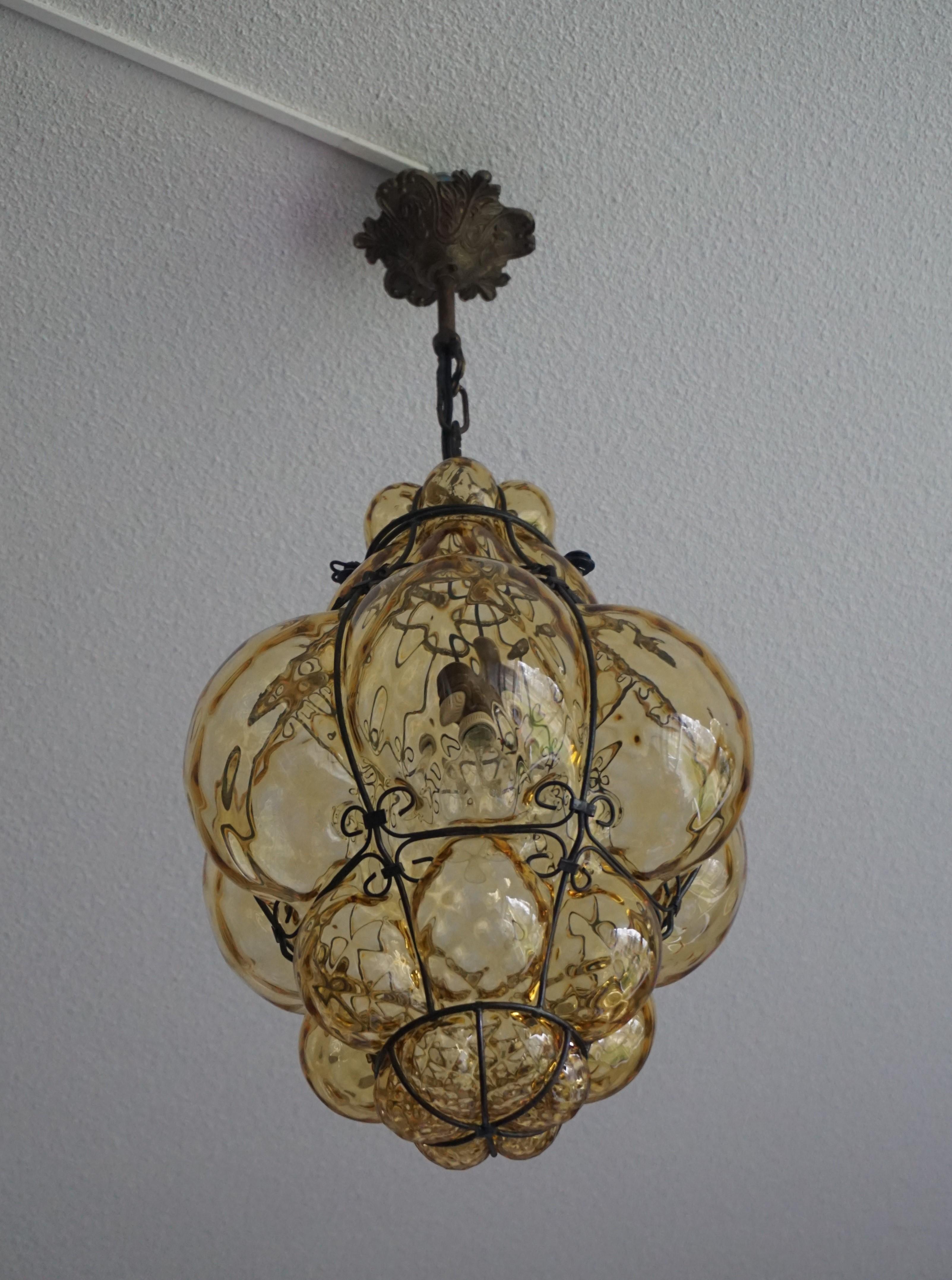 Early 20th century, Italian craftsmanship pendant. 

This good size and stylish single light pendant is beautiful in shape and the mouth blown, amber glass is in very good condition. It comes with a chain and canopy that both guarantee easy height