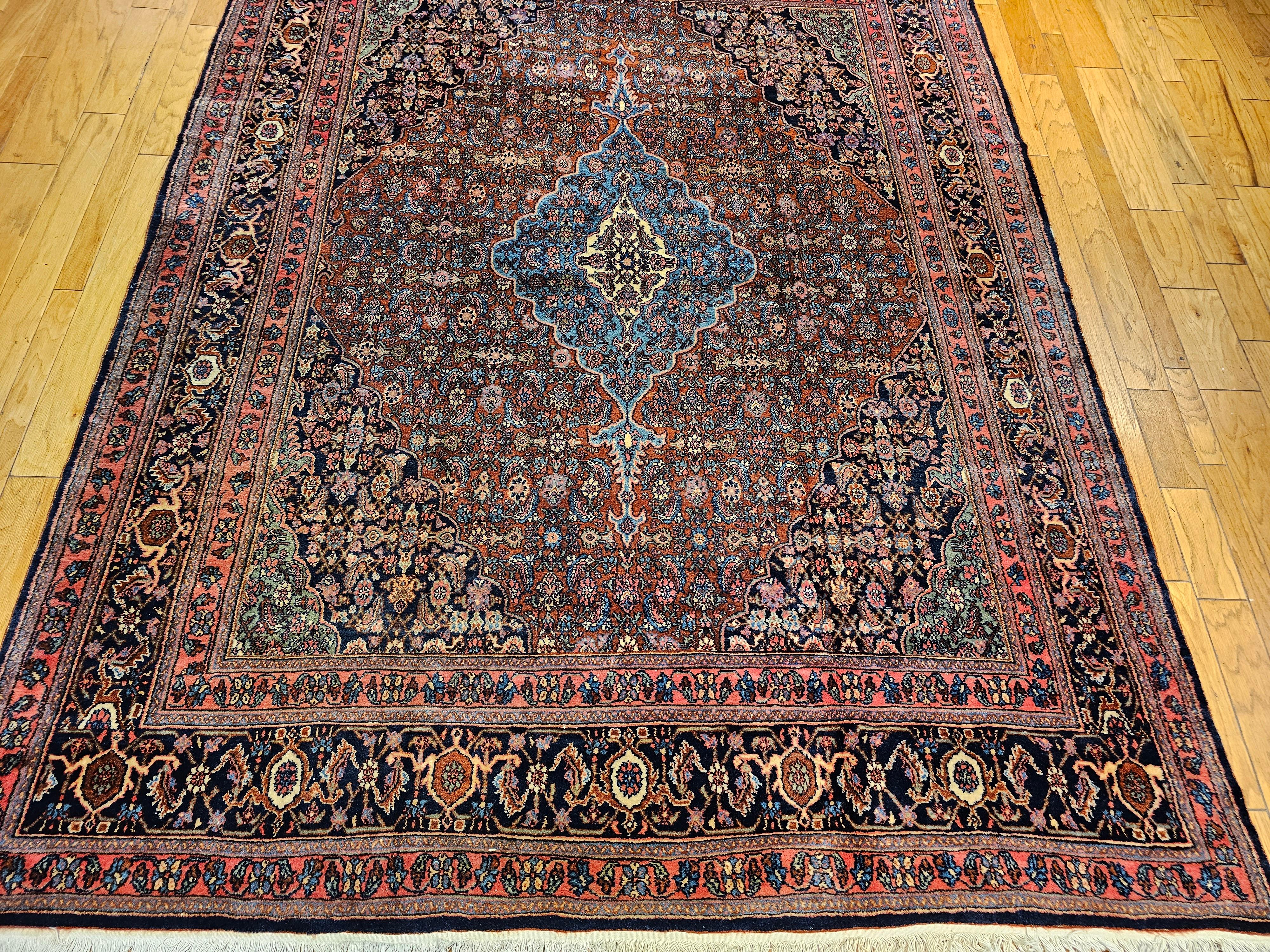  A vintage Persian Bibikabad in Herati pattern  in a rust red, French blue, and green colors from the early 1900s.  The Bibikabad rugs are recognized for their unique and beautiful elongated medallions which is part of their signature design.  The