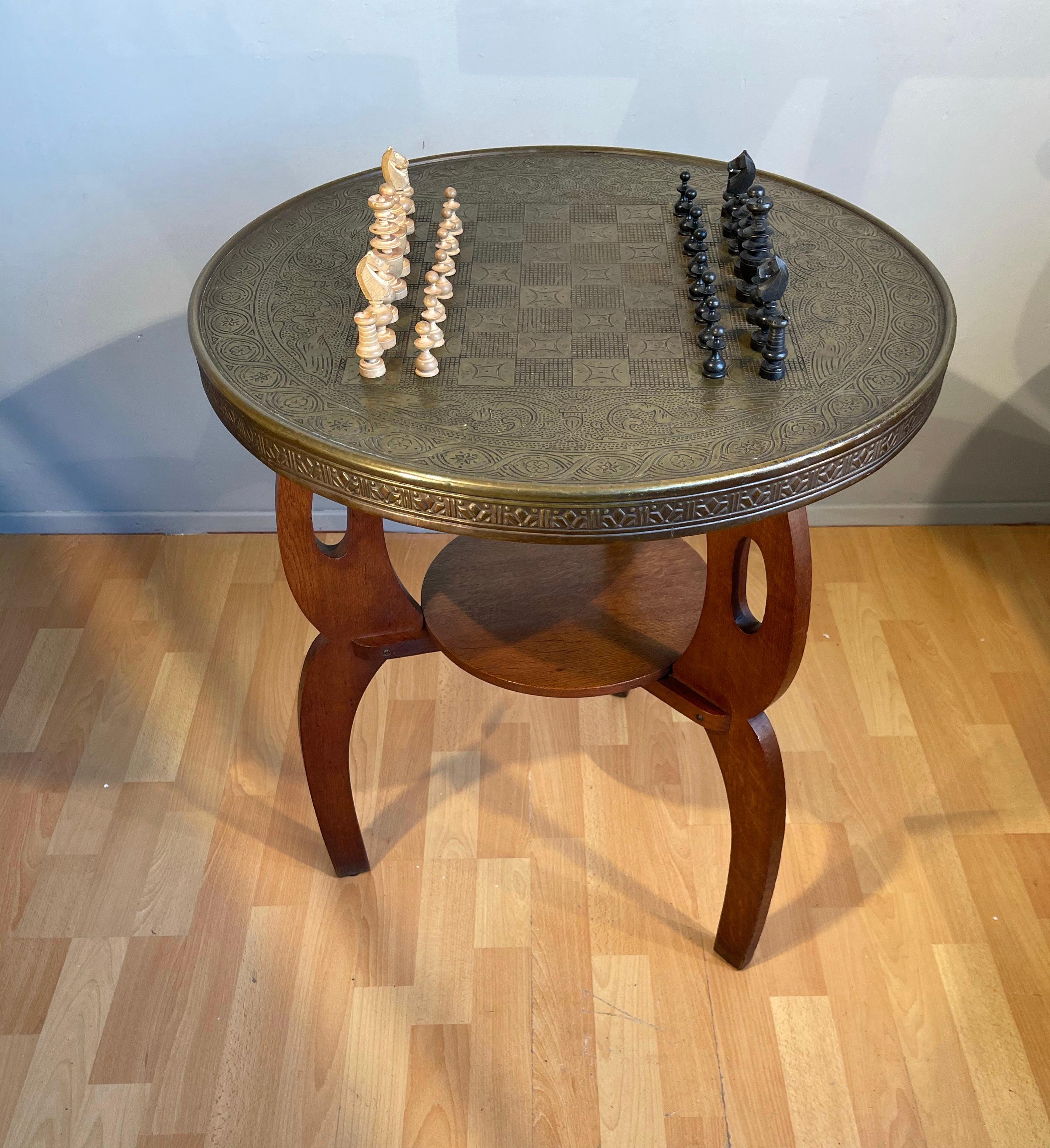 Antique Arts & Crafts chess table for playing the game in style.

The combination of the beautifully designed, tiger oak base and the embossed brass table top is of a style and class that you just don't find anymore. To find a unique chess table