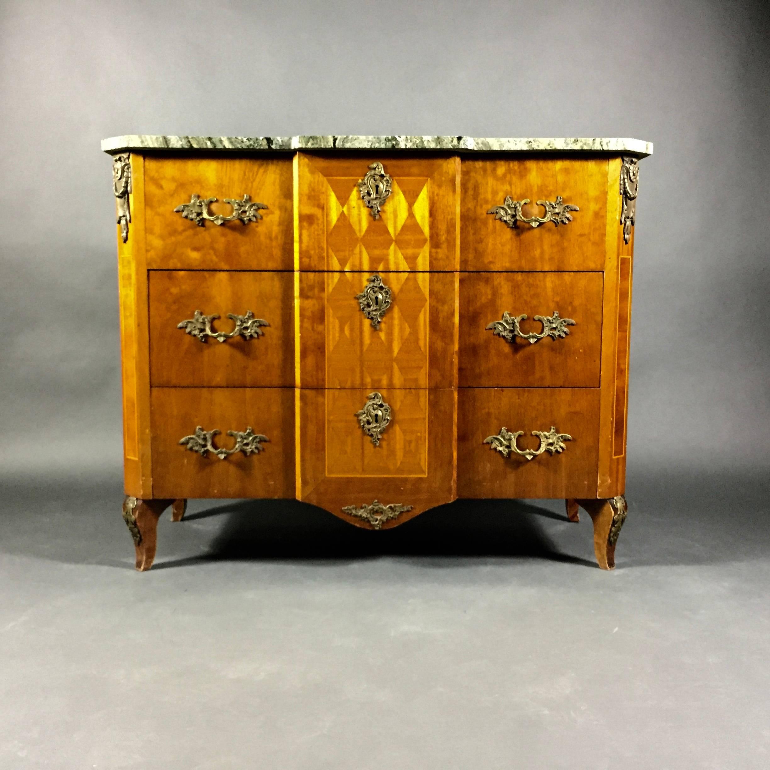Created in the Art Nouveau period this four-drawer dresser in beautiful lacquered mahogany includes geometric intarsia to the raised centre and dresser sides. Exceptional detail to brass accents, drawer pulls, key plate, leg at top and bottom. Top