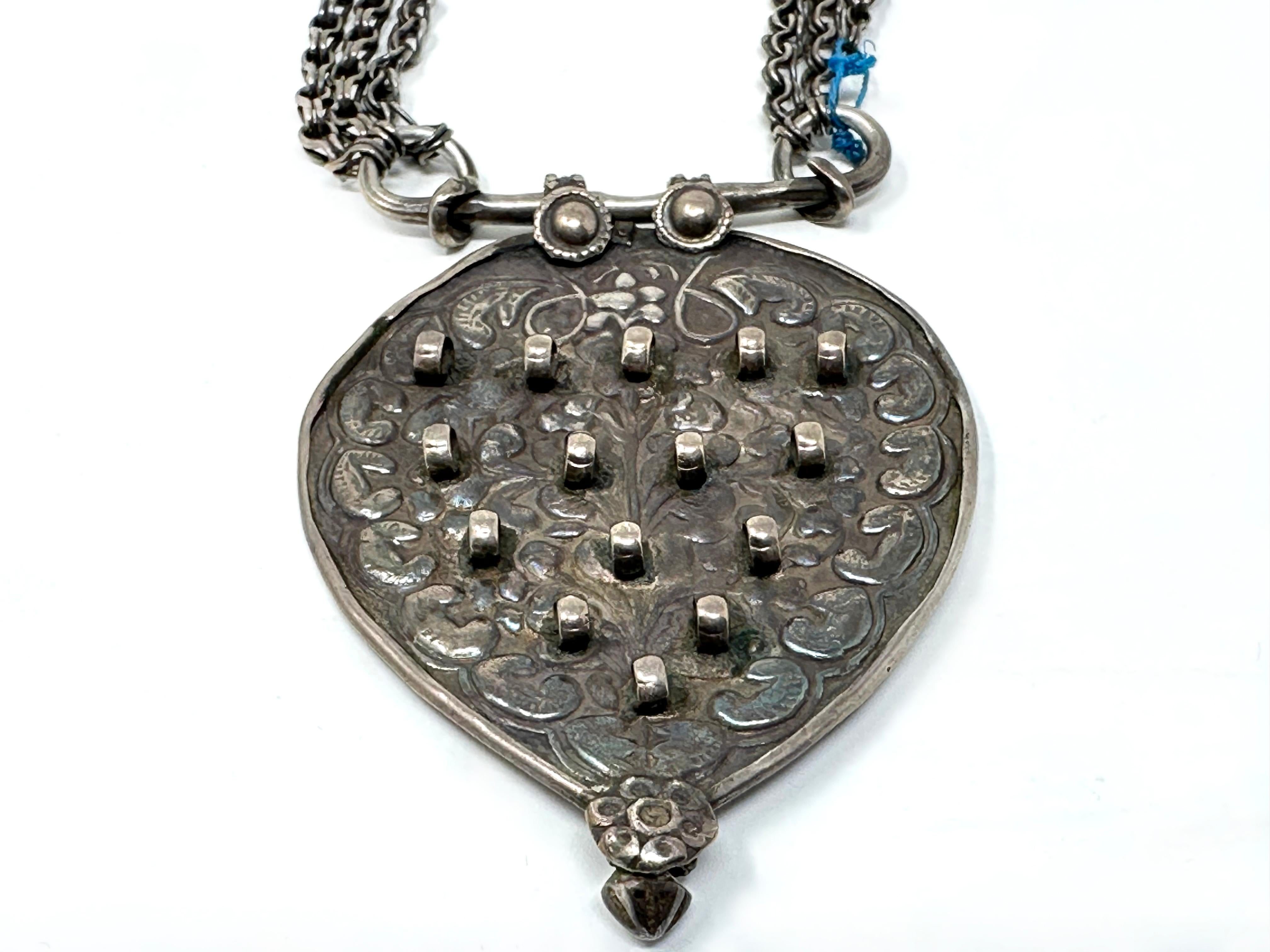 EARLY 1900’s Tribal MUGHAL INDIAN OLD SILVER NECKLACE
Intricate one of a kind three dimensional piece  in Old Silver.
Large heavy piece with repousse design on verso. Triple hand forged link chain in old silver. 
As seen in the photographs the end