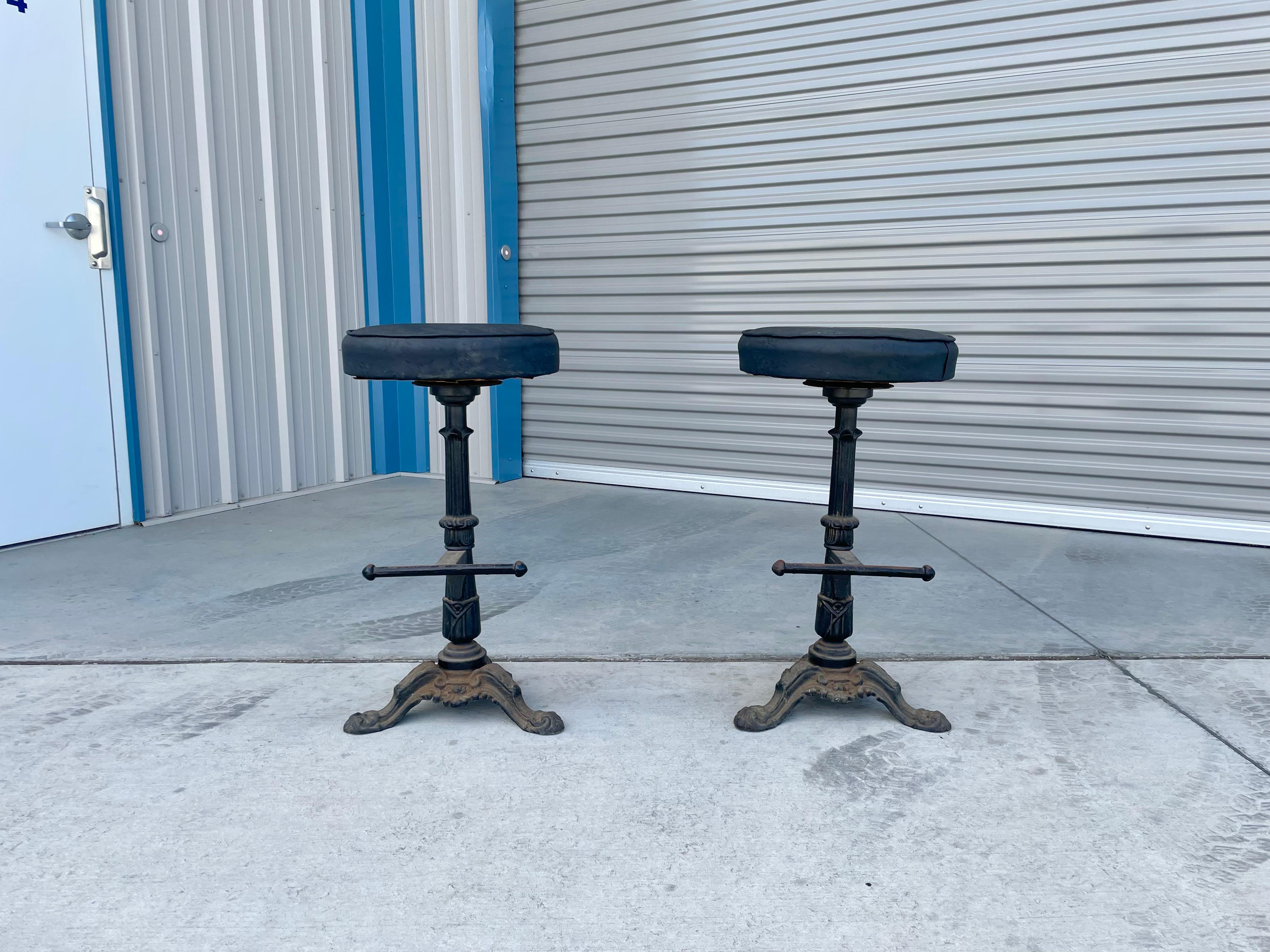 Vintage cast iron swivel bar stools were designed and manufactured in the United States during the 1900s. The stools are absolutely gorgeous, featuring a sturdy iron frame that exudes a timeless charm. What's more, they are incredibly comfortable to