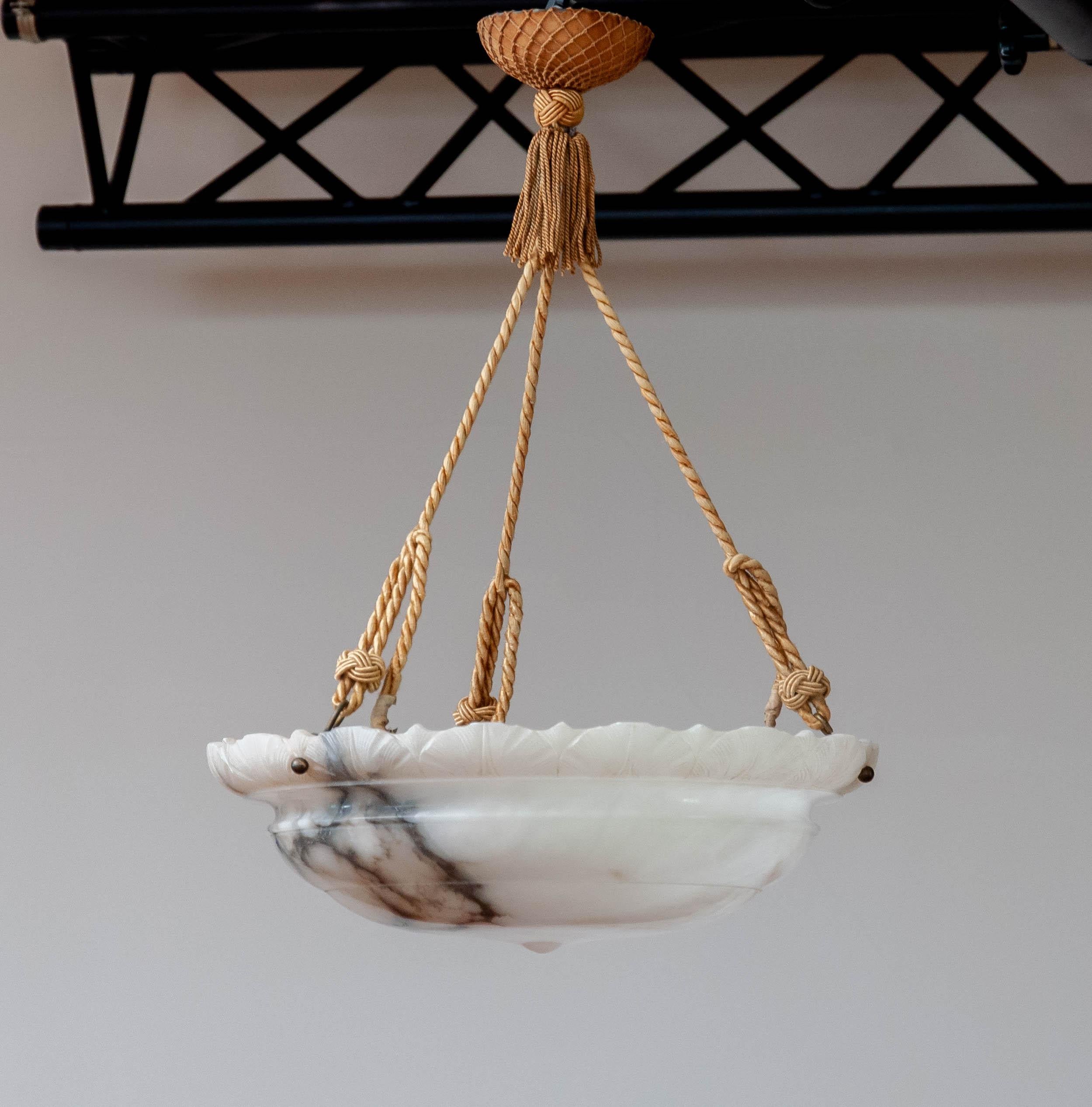 This pendant is made of a beautiful selected Volterra alabaster and radiates great warm feeling and class once it's in your home. Especially switched on the natural patterns generated by the grey and black veins are a beautiful displayed