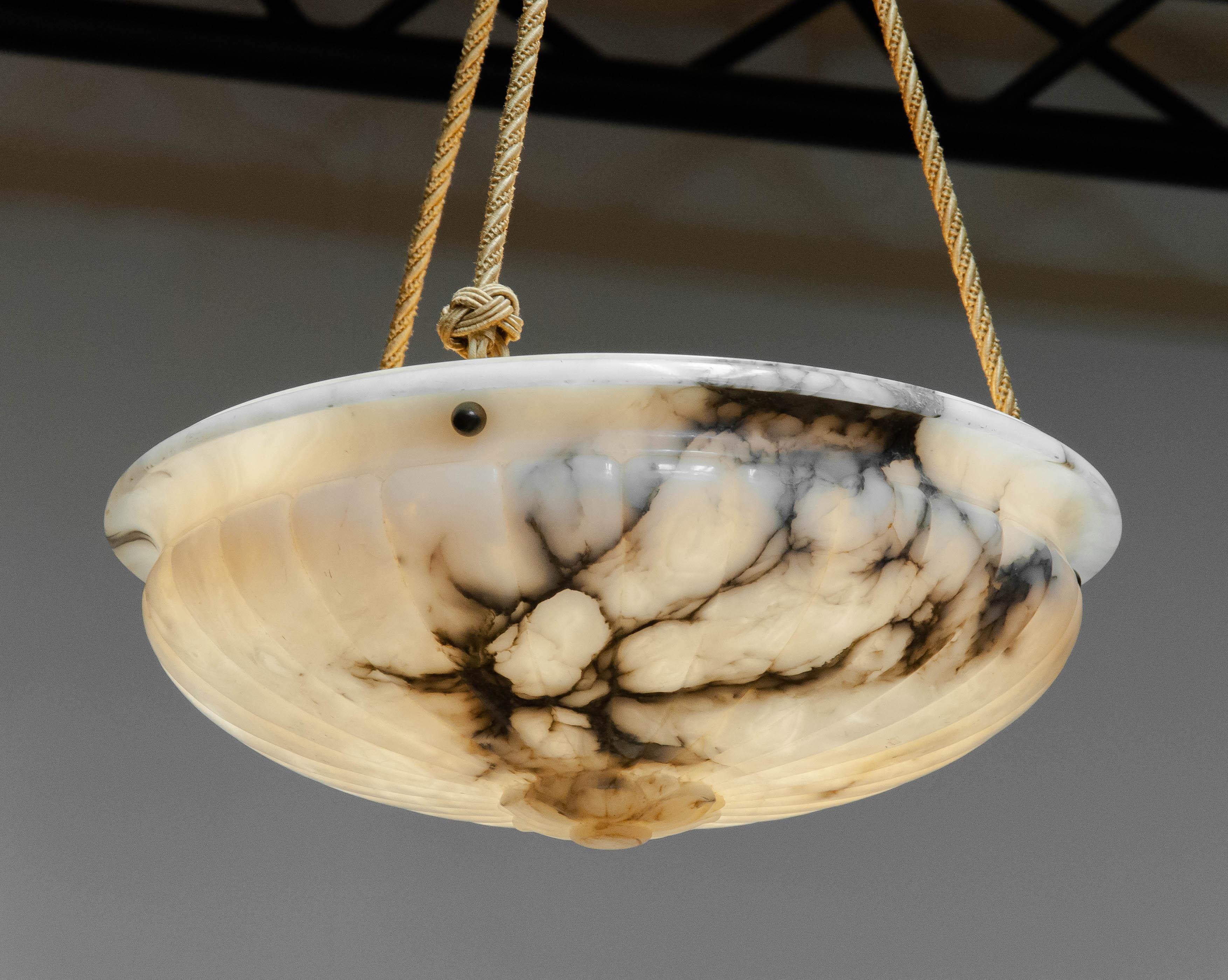 Beautiful alabaster up-light / chandelier made in the 1930s in Sweden. In the centered underneath an engraved flower in Greek style. Using Greek symbols was very popular at that time.
The up-light stil has her original wiring and cords and one screw