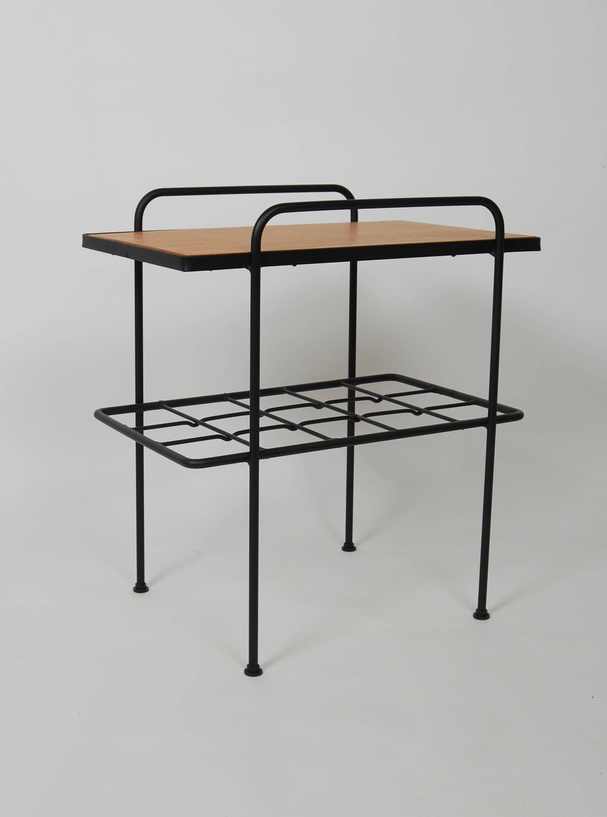 Black lacquered iron frame with heavy wire grid shelf with honey colored birch wood top by Inco of California. Part of the early postwar design style emerging out of Southern California.