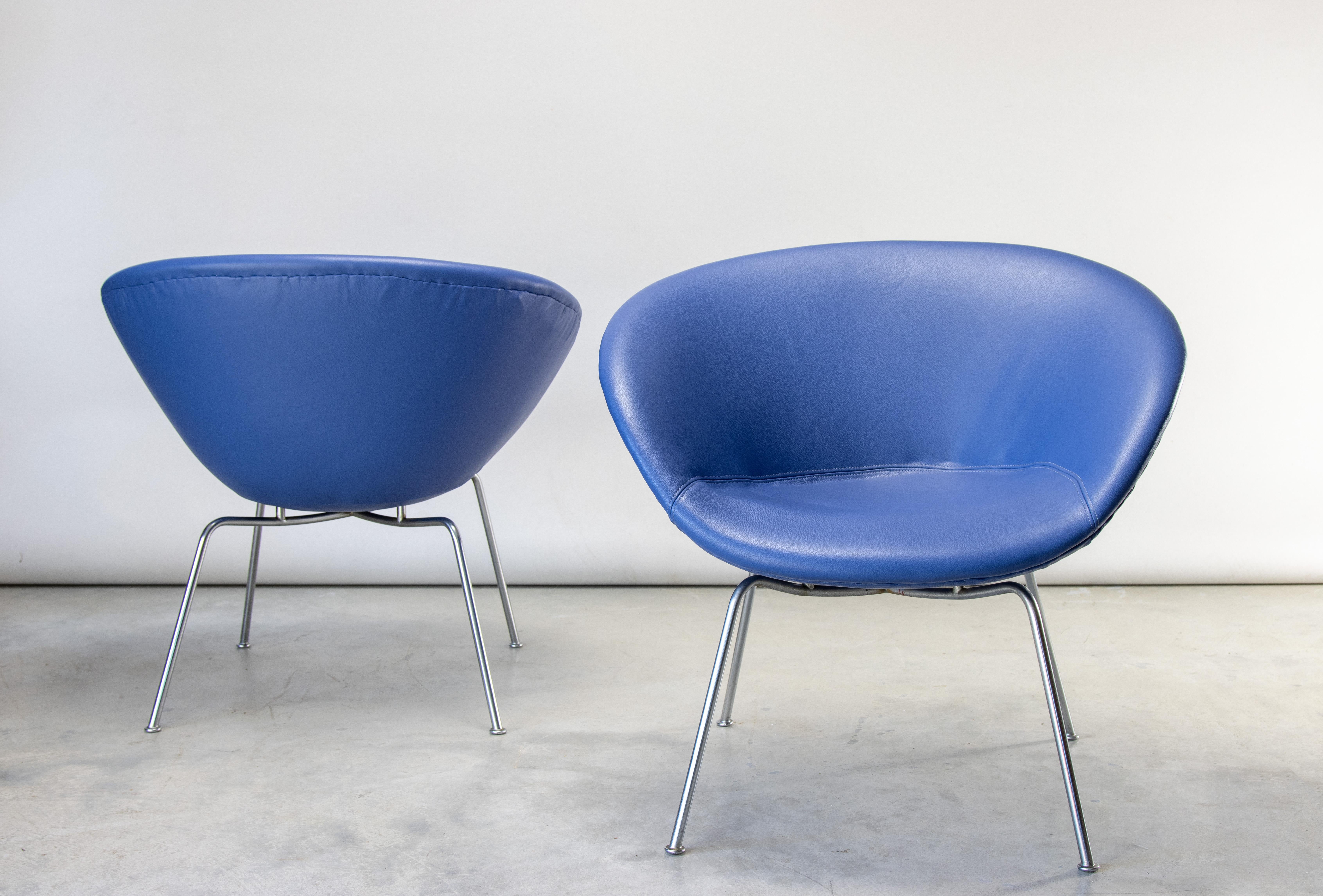 Iconic Pot chairs designed by Arne Jacobsen for Fritz Hansen. these examples are early with the white stamp. The original wool upholstery was replaced with a similar cornflower blue leather. A unique minimalist form that appears to float off of the