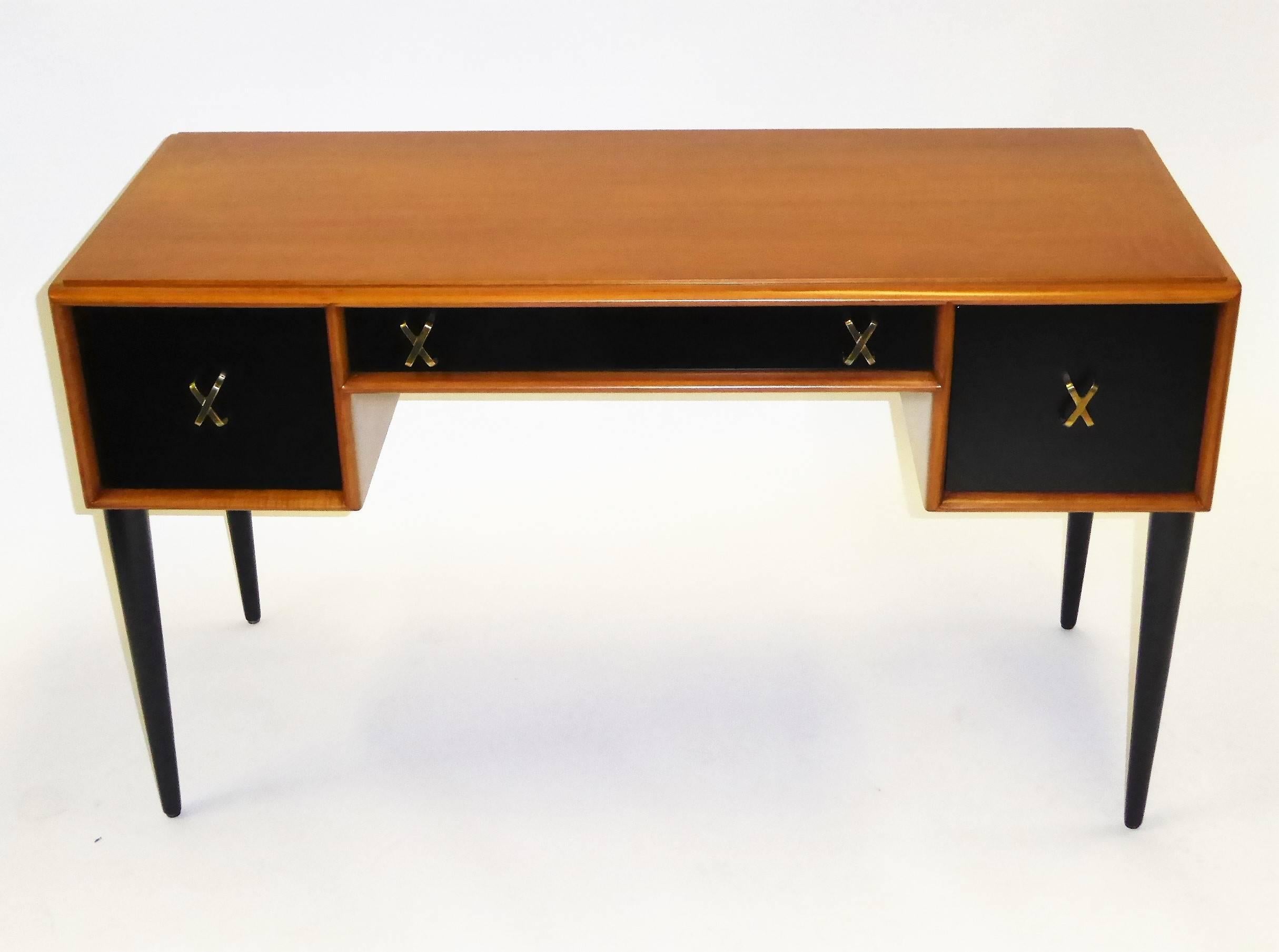 Rarely seen exquisite Paul Frankl designed mid century modern desk or vanity in cherry and black satin lacquer with brass X-pulls. With a John Stuart store tag and made by Johnson Furniture Company in the early 1950s. Beautiful figured wood, finely