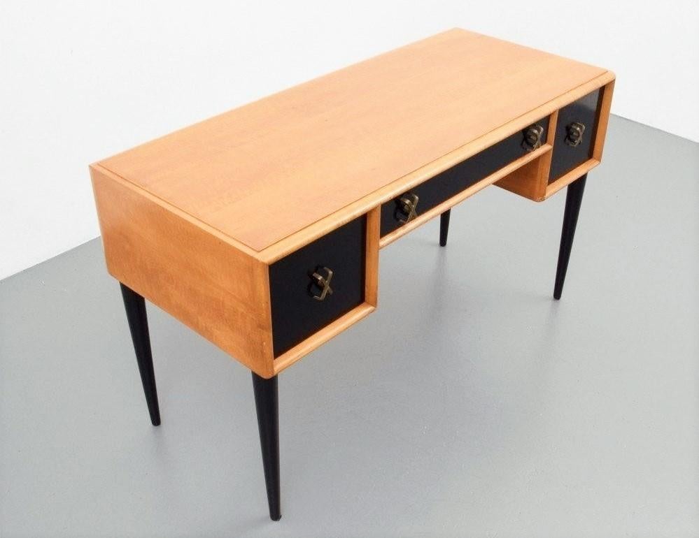 This fine example of early 1950's streamlined furniture designed by Paul T. Frankl and made by Johnson Furniture Company. Two-tone black satin lacquer and bleached wood finish make this rather stunning. Featuring two side and one center pull out