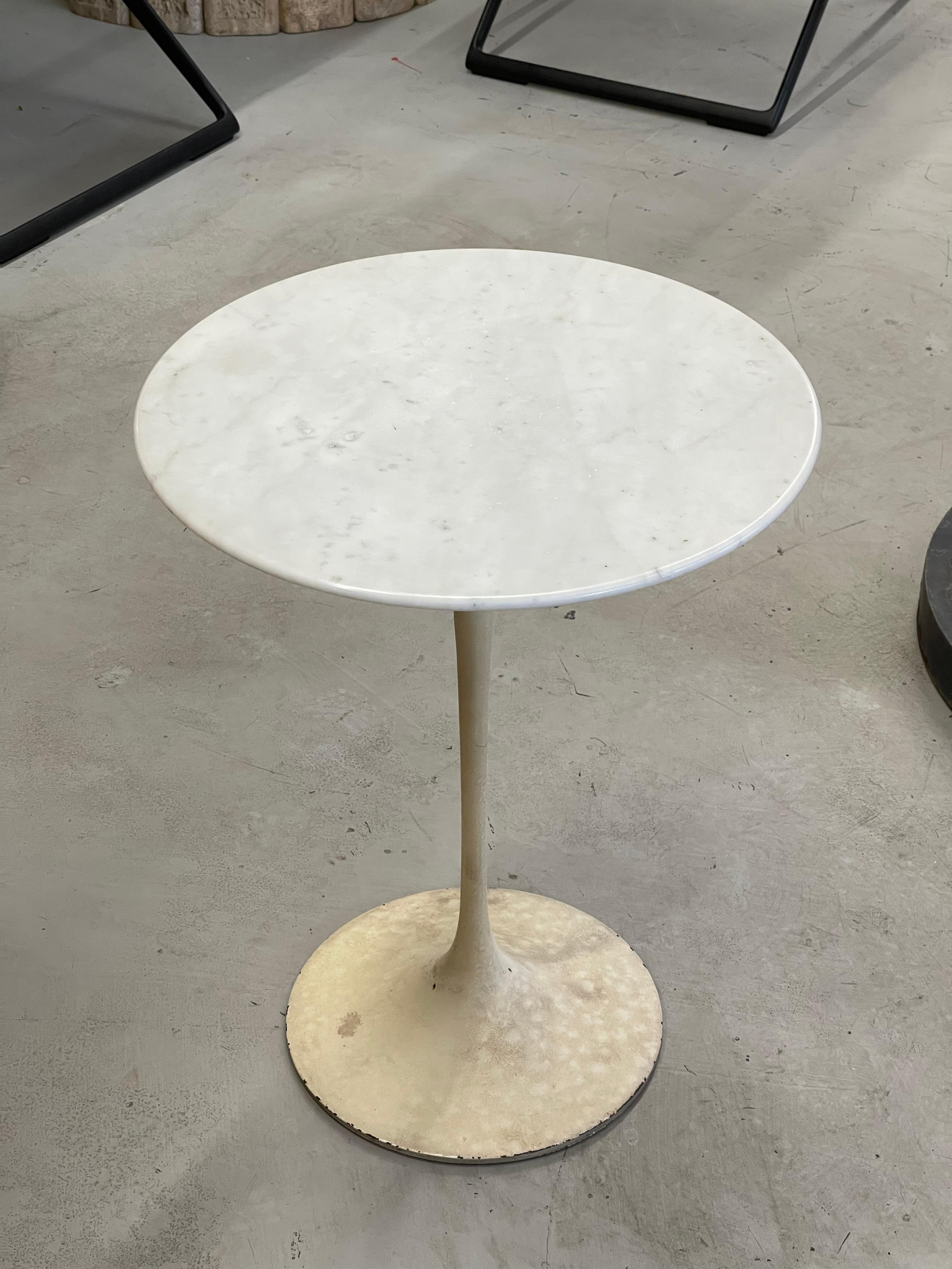 An extremely early production Knoll Eero Saarinen Tulip table. Bears a 575 Madison Ave New York 22 label. Marble Top is 16 inches in diameter. Slightly over 20 inches tall. The base is dirty but we elected not to repaint it due to its rarity. Top is