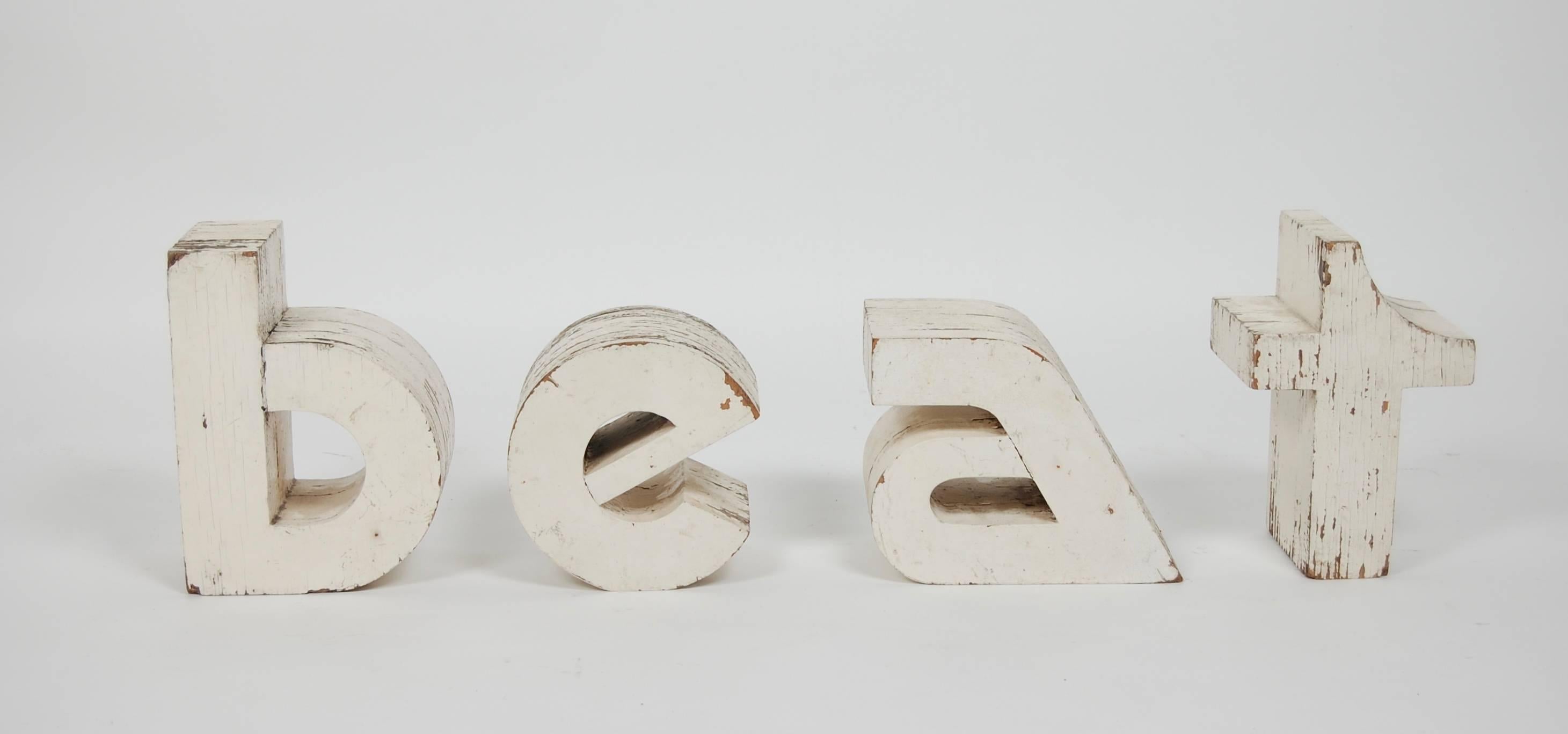 1960s vintage wooden signage from a record store. Distressed thick plywood letters that where originally painted white. The stylized font was cutting edge during this time period.