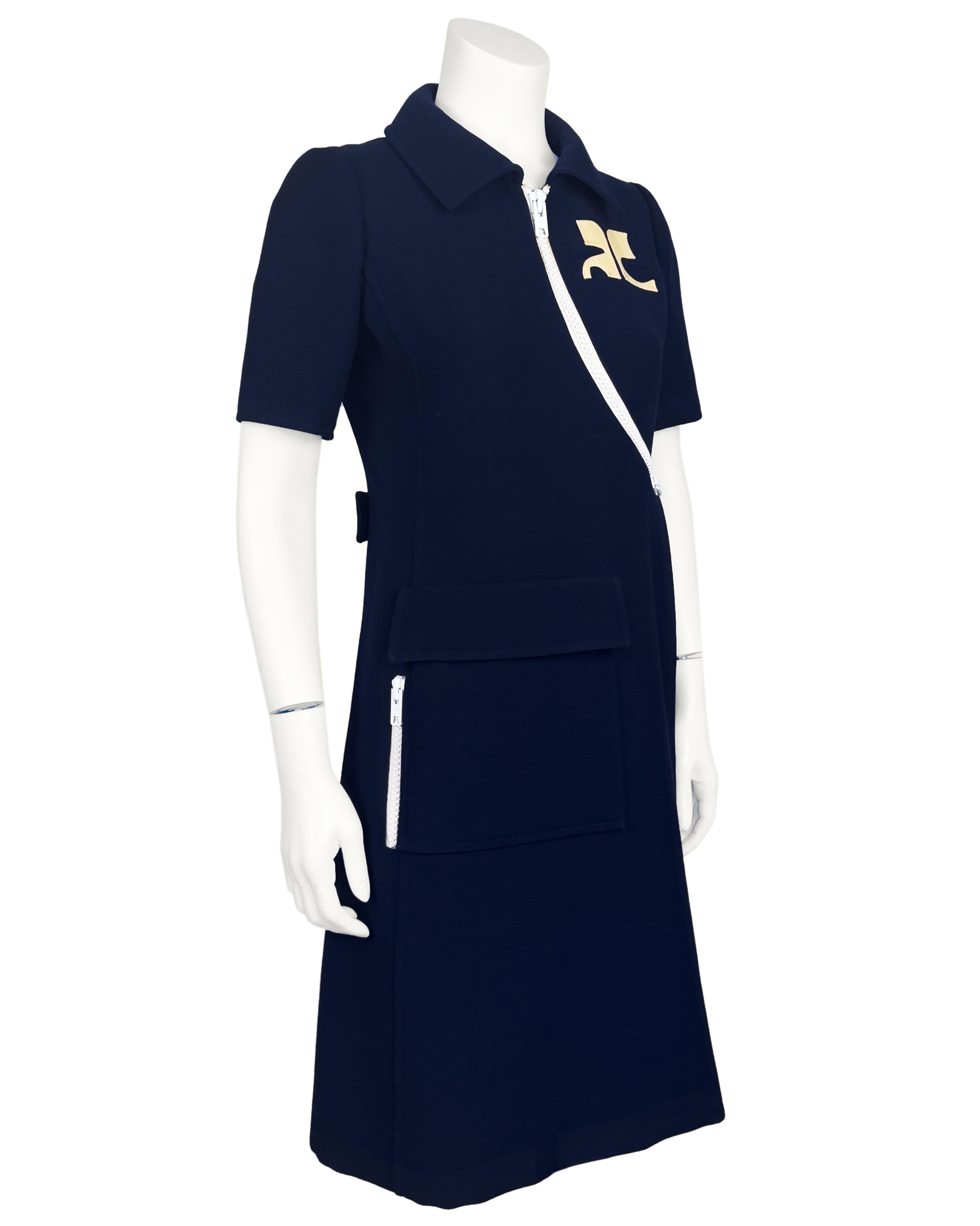 Step into the bold spirit of the mod era with this vintage Courrèges couture asymmetrical zip dress, an iconic piece from the house.. Crafted from navy blue wool crêpe, the dress features striking exposed white zipper accents in a distinctive