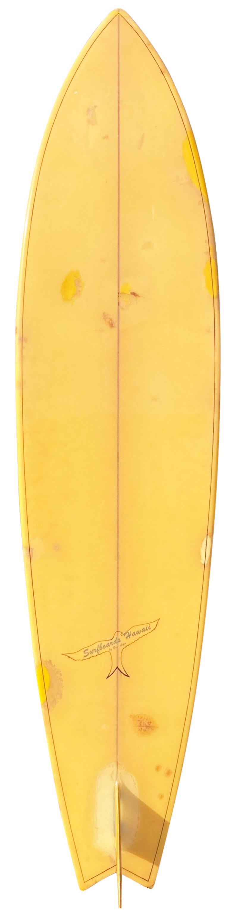 Early 1970s Surfboards Hawaii single fin shaped by Ben Aipa. Features a double pin line design, tri-color single fin, and the original Surfboards Hawaii swallow-tailed bird logo. This was the very first logo Aipa used when shaping for Surfboards