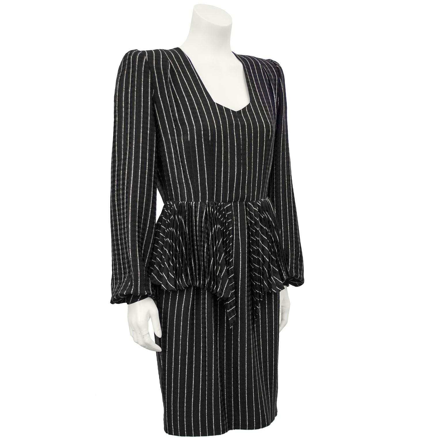1980s Andre Laug black and white pinstriped silk day dress with pleated peplum detail. The squared off V neckline is accented with shoulder pads and a pleated peplum detail at the waist. The dress falls to the just above the knee and has black