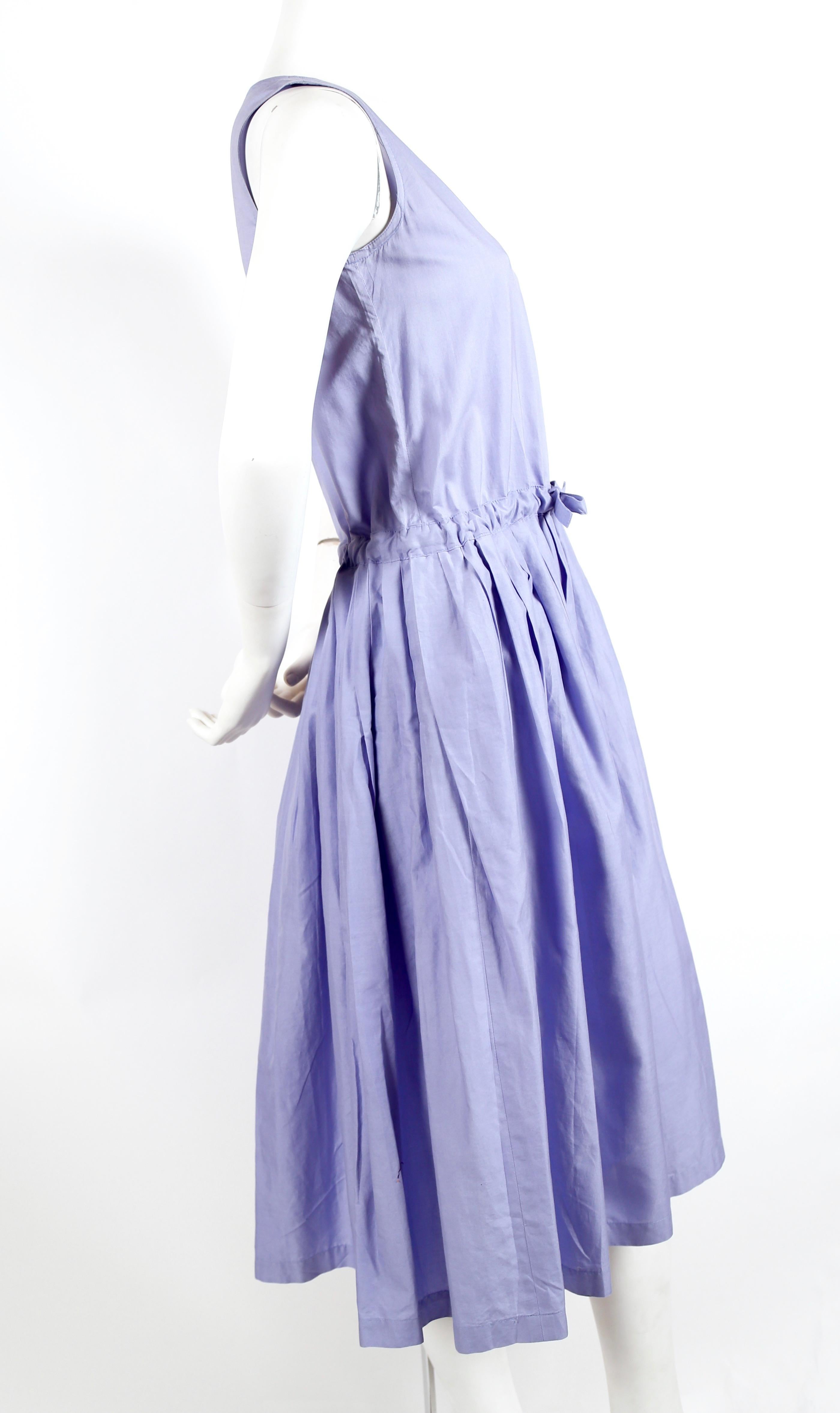 Periwinkle-blue, cotton day dress with pleats and drawstring waistline designed by Issey Miyake dating to the early 1980's. Labeled a JP 9. This dress best fits an XS or S. Approximate measurements: bust 32.5