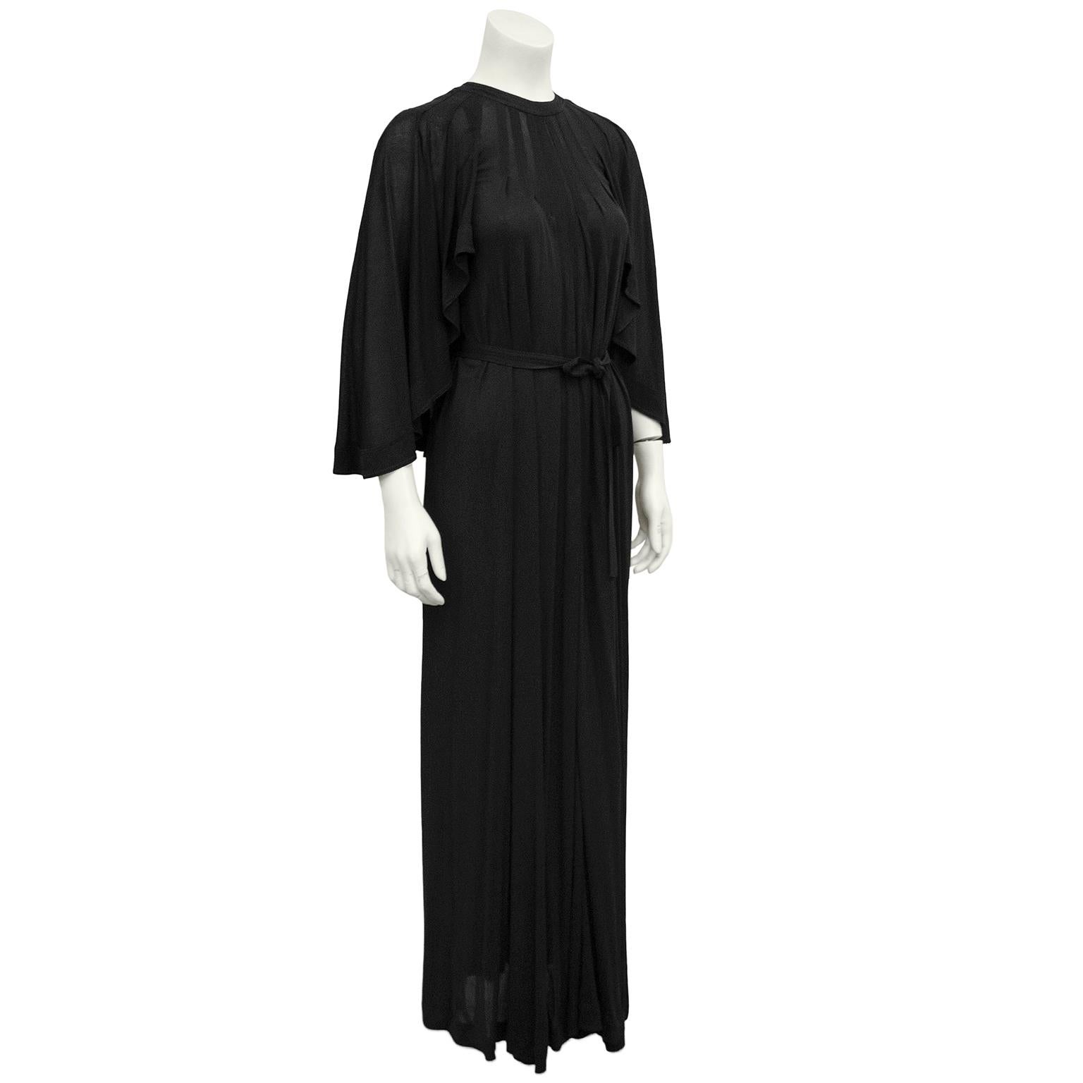 Early 1980s Jean Muir black rayon jersey gown. Features a demi cape back with long flowing sleeves. Smocking detail at yoke & tie at waist. Pockets. Very bohemian chic. Excellent vintage condition. Fits like a size 6/8 US