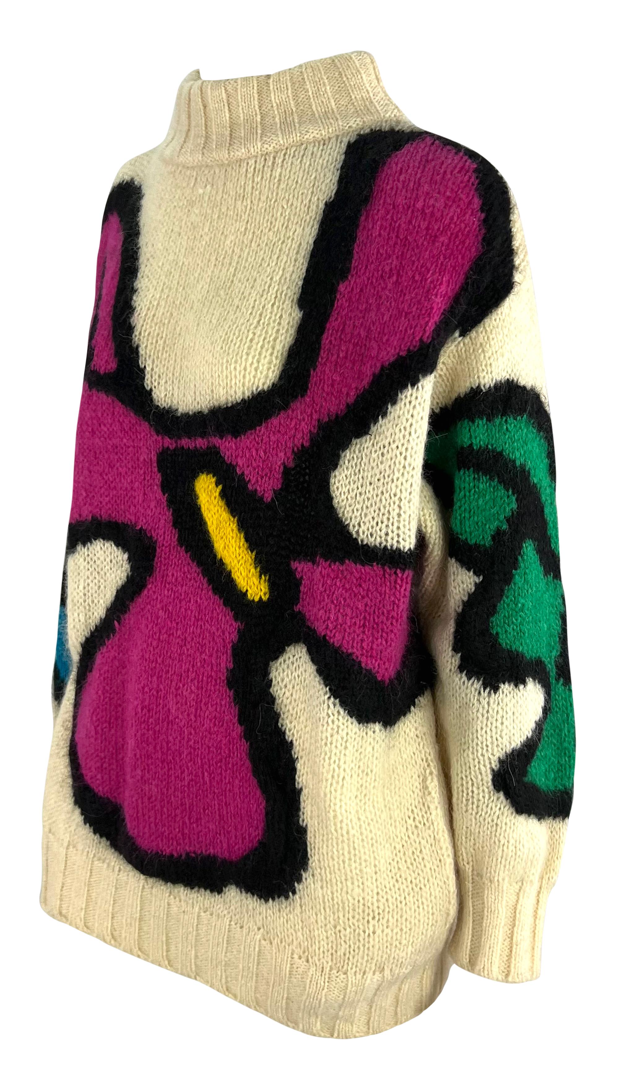This winter white knit sweater by Thierry Mugler, dating back to the early 1980s, features a bold abstract floral print. The top is finished with a wide knit design and a mock neck. 

Approximate measurements:
Size - removed
Shoulder to hem: