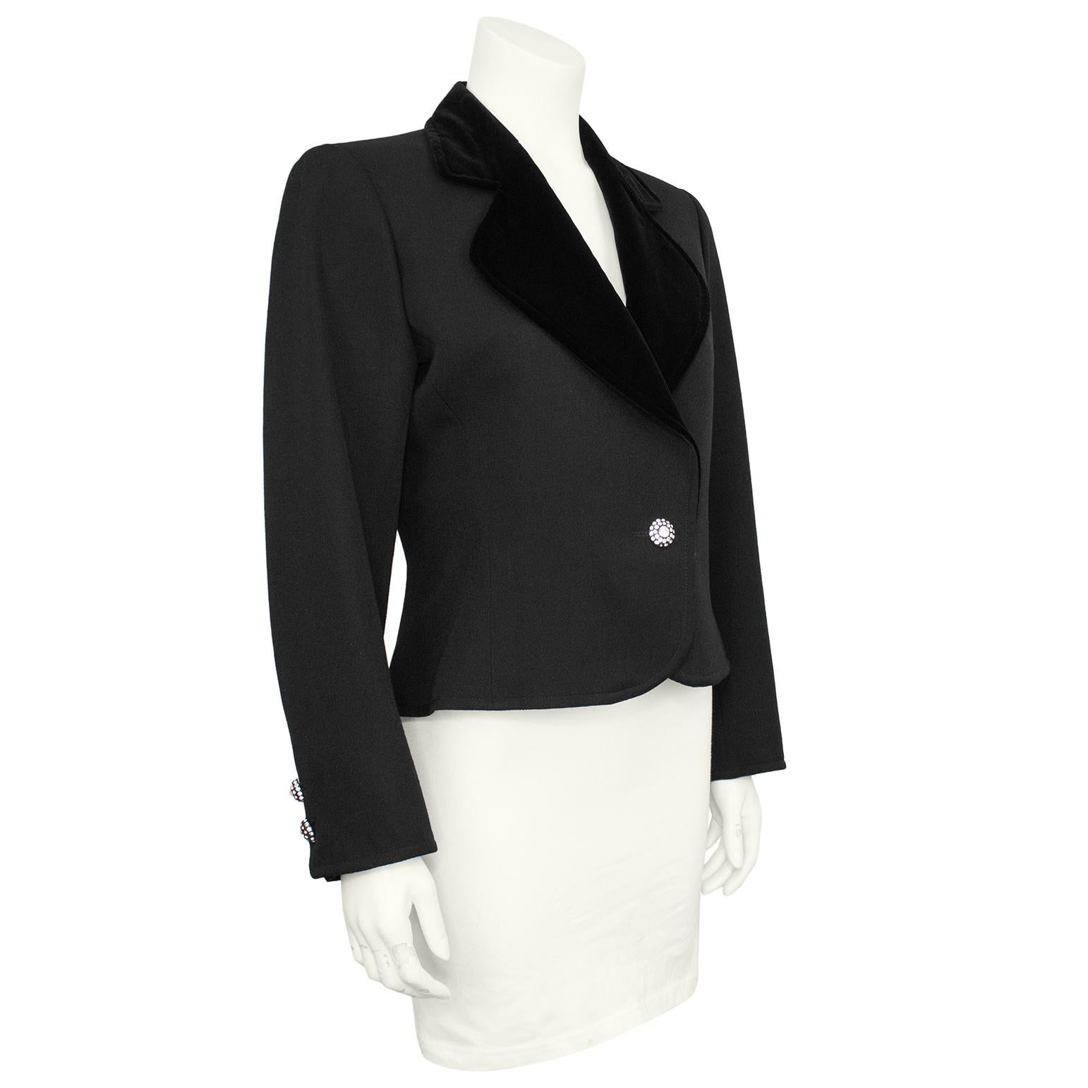 Late 1970s, early 1980s YSL Rive Gauche label cropped black evening blazer. The wool gabardine blazer is accented with a black velvet notched lapel and finished with black acetate and rhinestone encrusted buttons at the closure and on the cuffs.