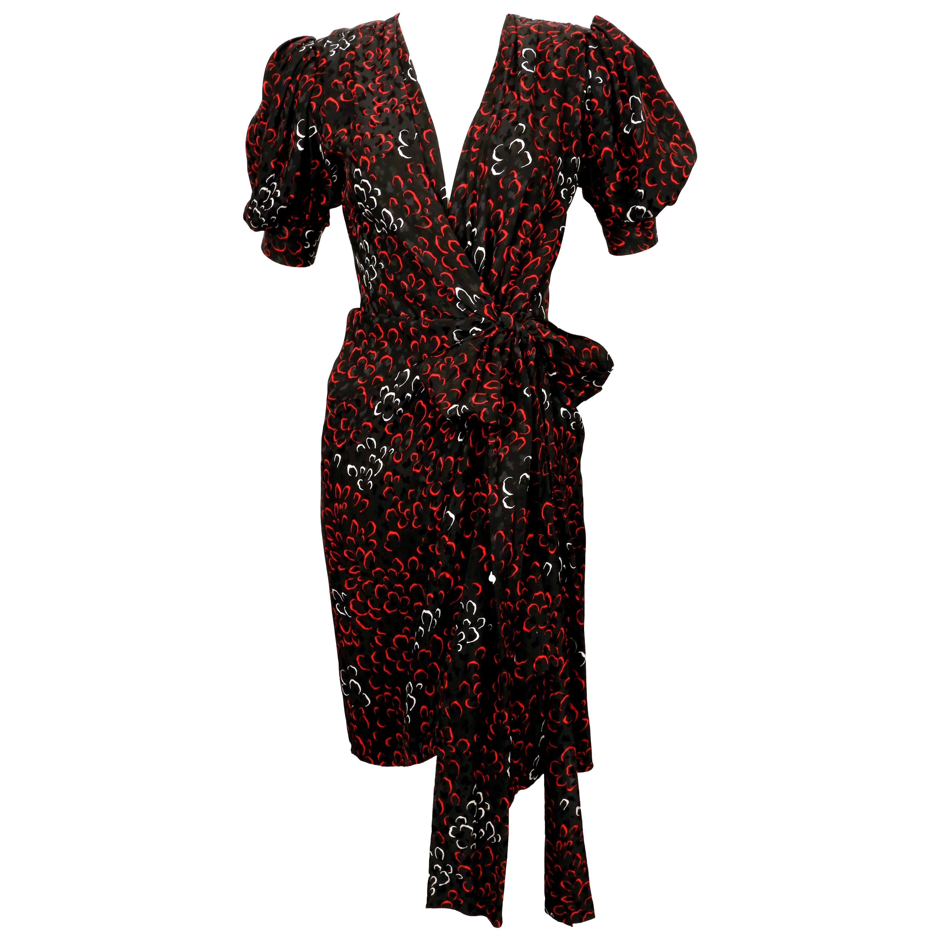 Abstract-printed, silk wrap dress from Yves Saint Laurent dating to the early 1980's. Colors are jet black, red and white. Labeled a French size 34. Approximate measurements: shoulder 14.25