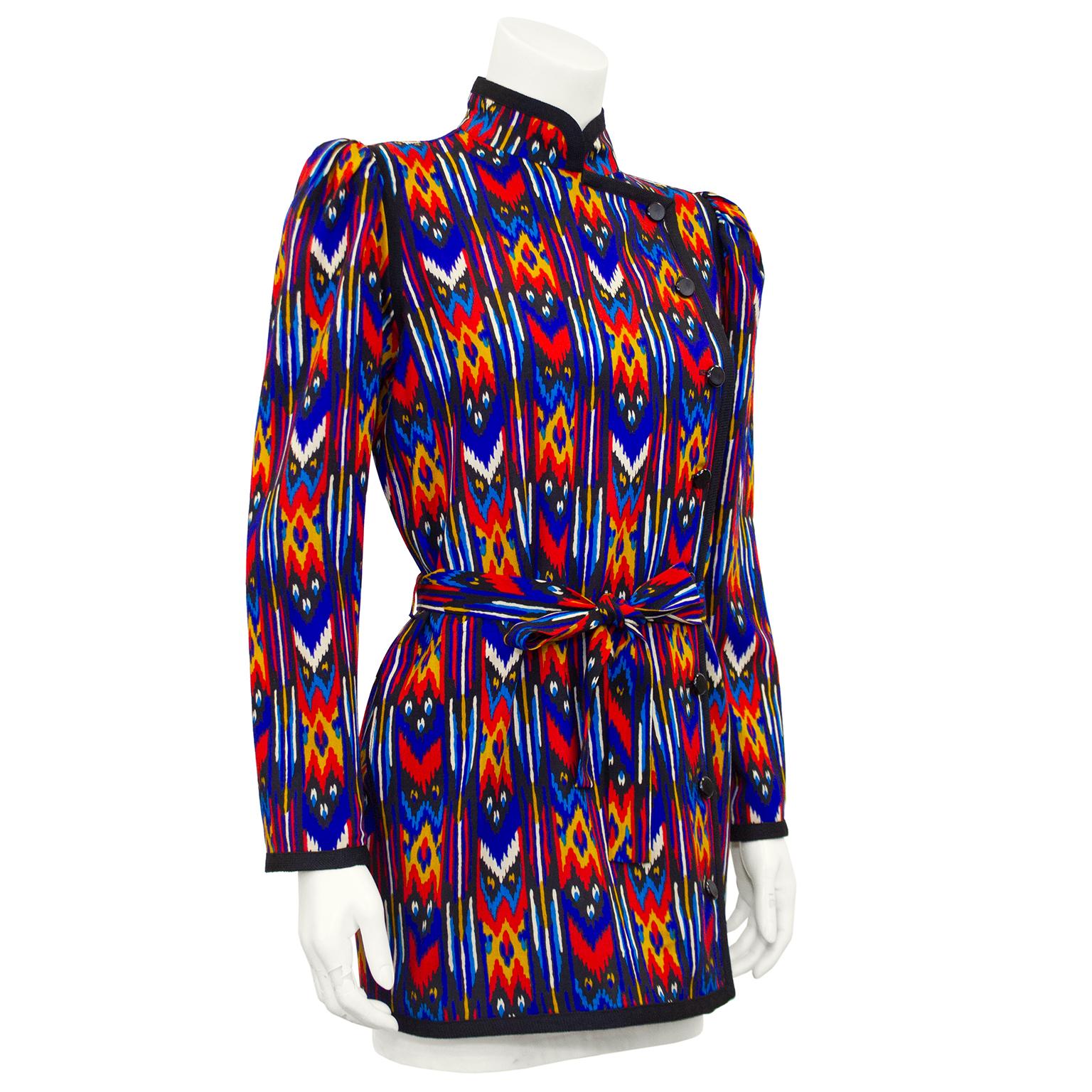 Yves Saint Laurent Rive Gauche very lightweight cotton jacket from the early 1980s. Bright blue, orange and yellow all over Navajo print. Long sleeve with Mandarin collar and optional matching belt. Black trim and black round plastic buttons up left
