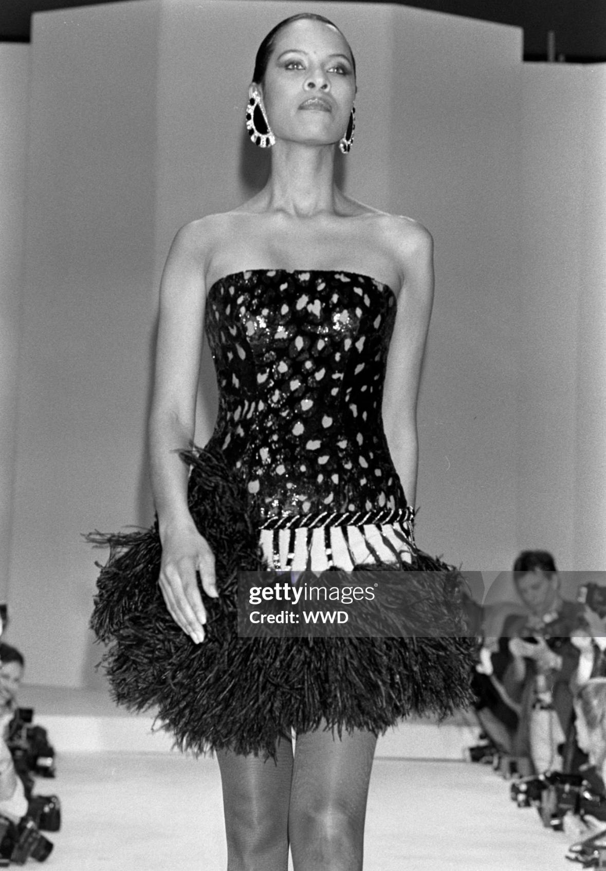 Presenting an incredible jaguar patterned Bob Mackie mini dress. A yellow variation of this dazzling dress debuted on the Fall/Winter 1988 runway and was worn by Bernadette Peters with Mackie to the 1988 MET Gala. This custom purple strapless mini
