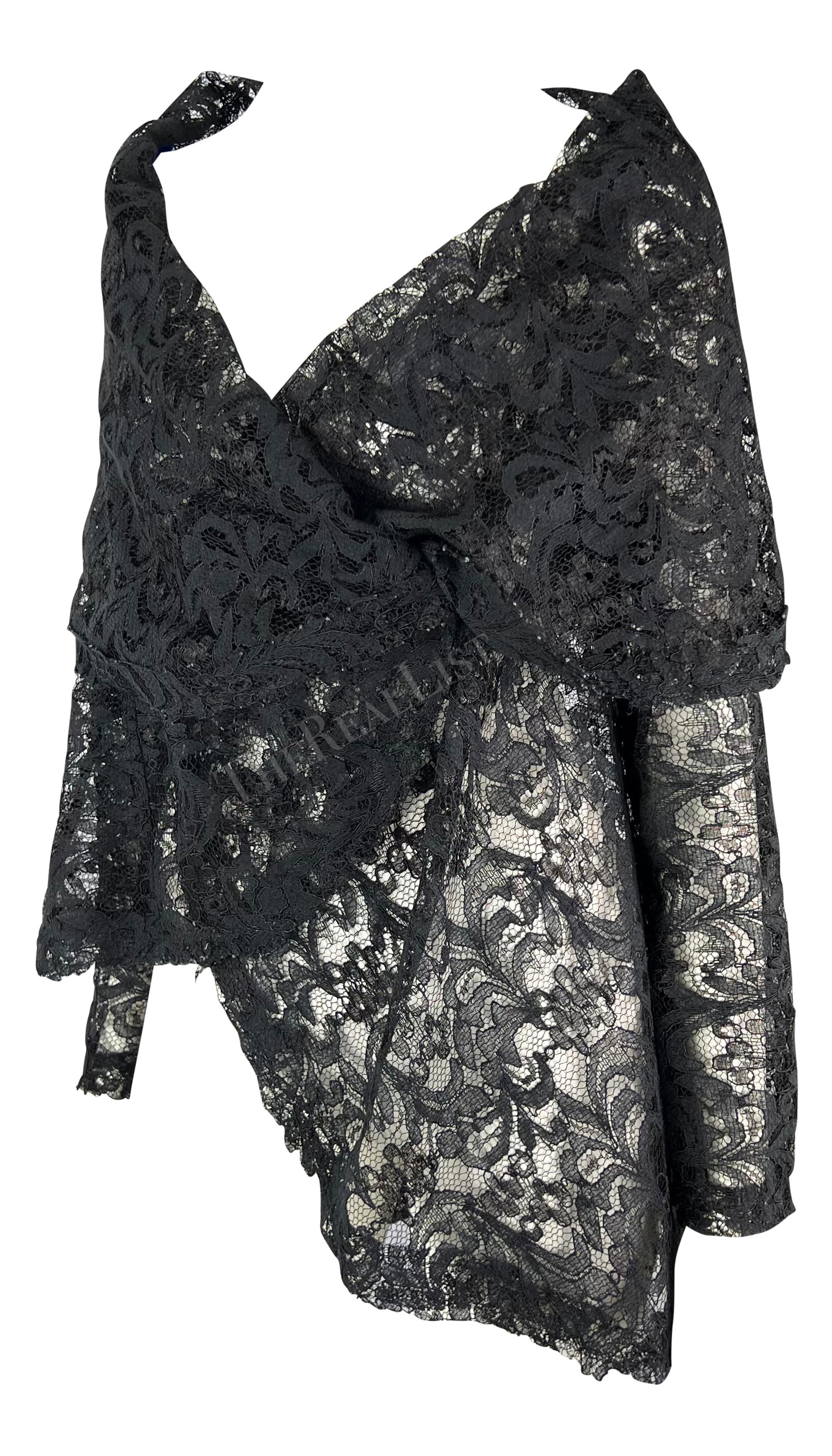 TheRealList presents: a fabulous black lace Dolce & Gabbana wrap. From the early 1990s, this piece can be worn as a top or jacket and is constructed entirely of black lace. This oversized wrap top features a v-neckline and a fold-over collar.