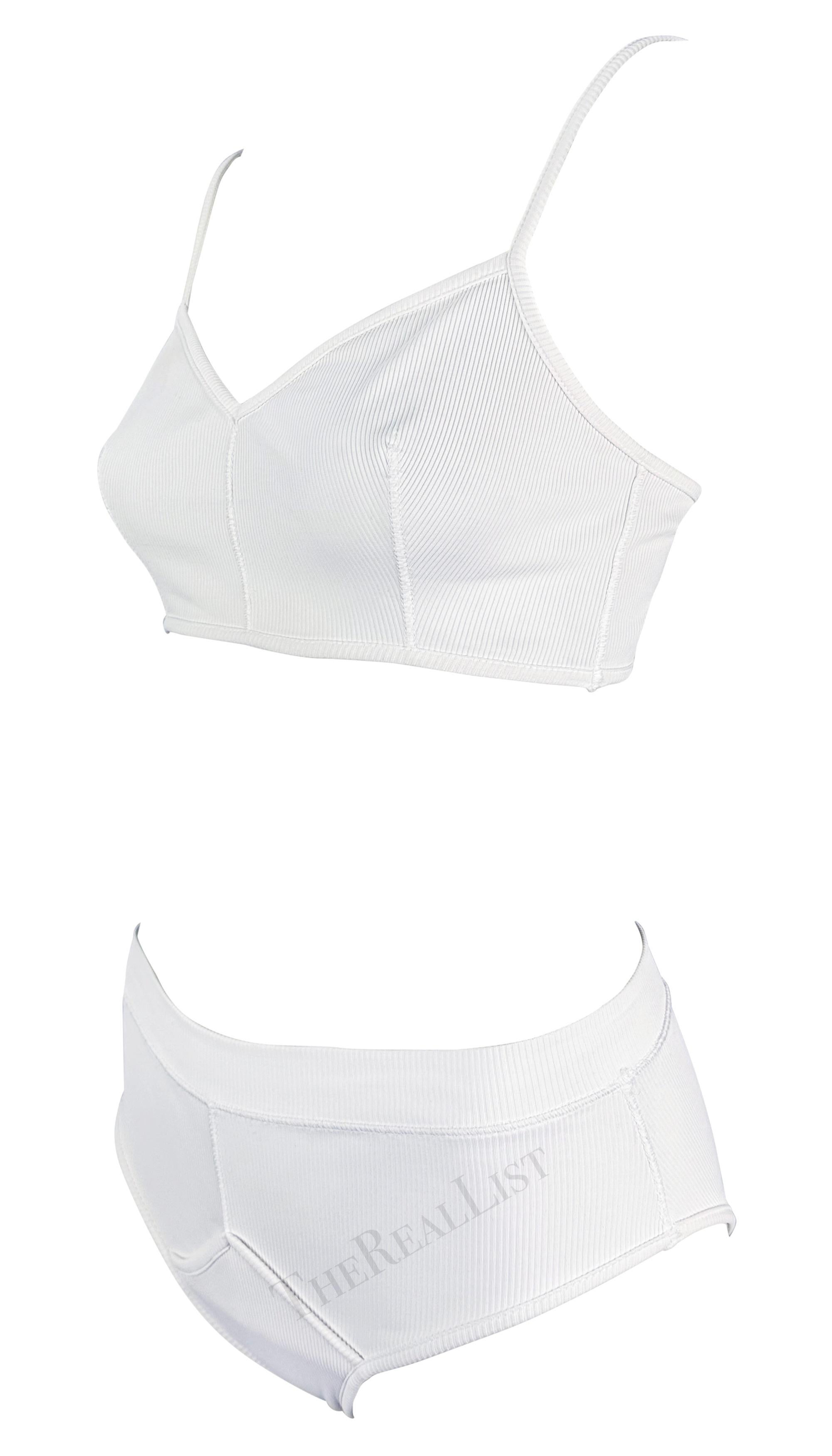 Presenting a white ribbed Dolce & Gabbana beach bikini set. From the Spring/Summer 1994 collection, this matching set consists of an ultra-cropped tank top and high-waisted briefs. The top features spaghetti straps and a v-neckline. The matching