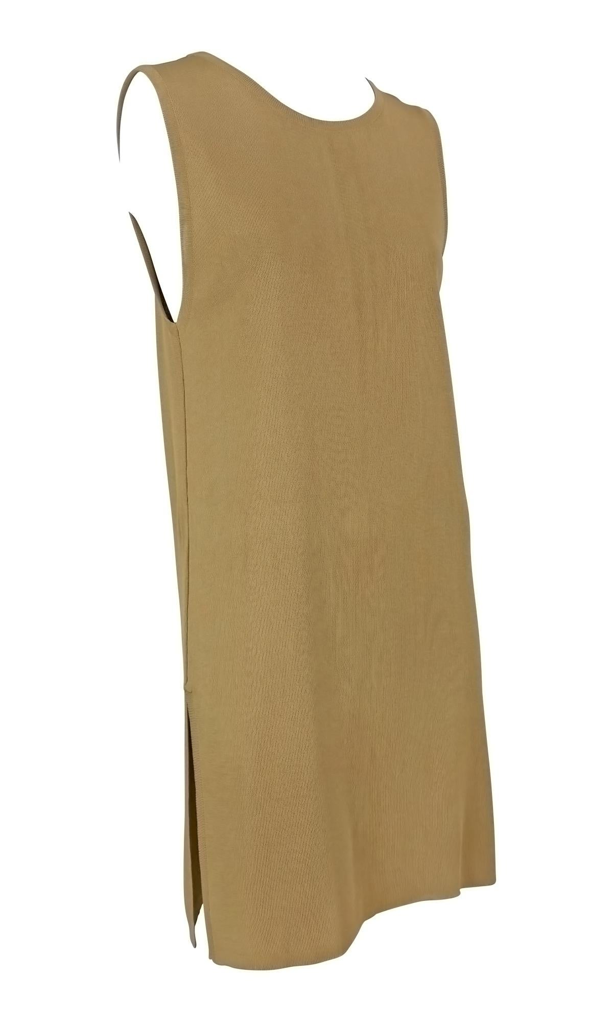 From the early 1990s, this Donna Karan shift dress is crafted from a soft tan stretch knit. Made in italy, the dress features a clean sleeveless silhouette with a crew neckline and slits at either side. 

Approximate measurements:
Size - M
Bust: 36”