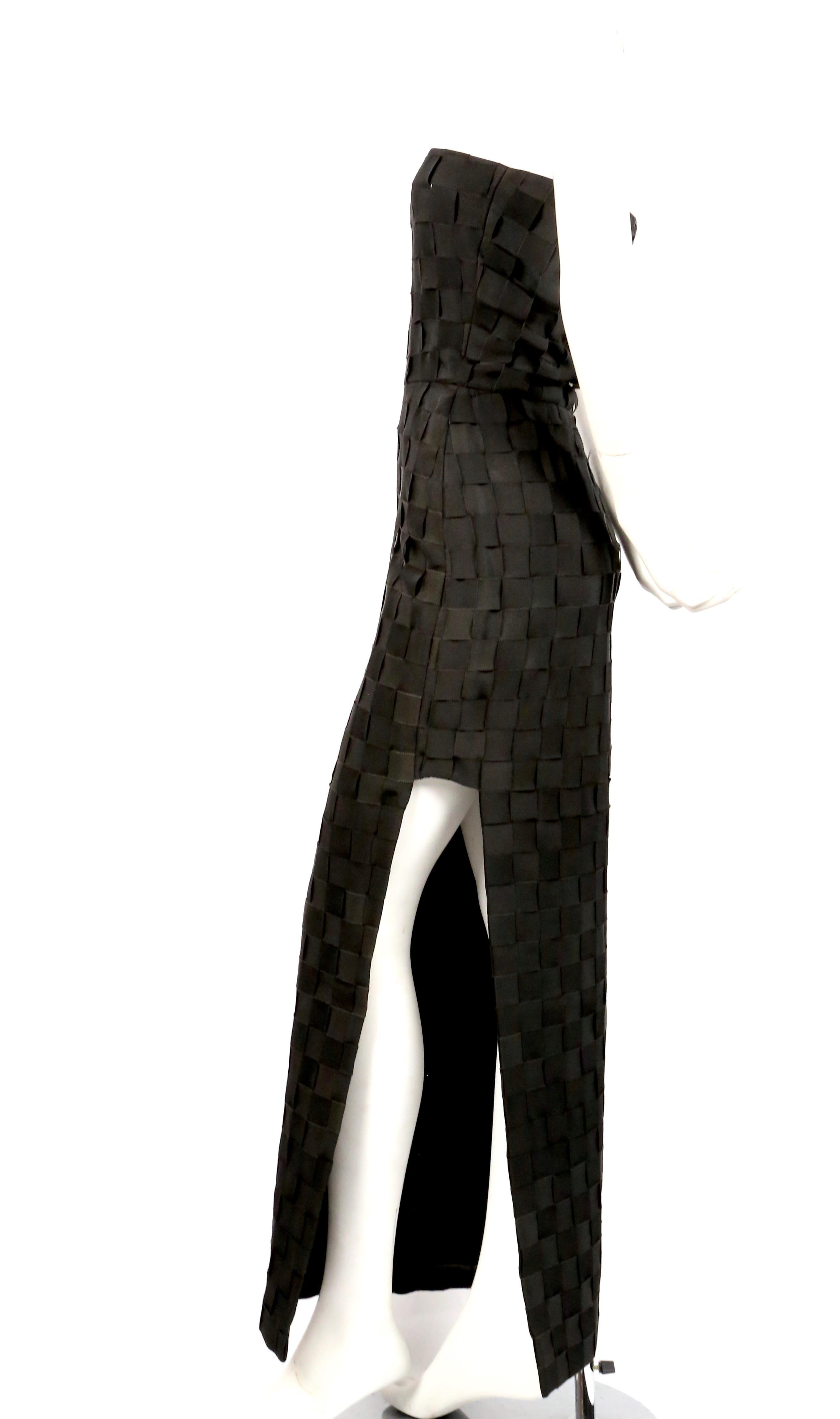 Black woven grosgrain ribbon strapless dress with cut out at left leg designed by Gianni Versace for the Gianni Versace Couture label dating to the early 1990's. Best fits a US 2. Approximate measurements: bust 31.5-32