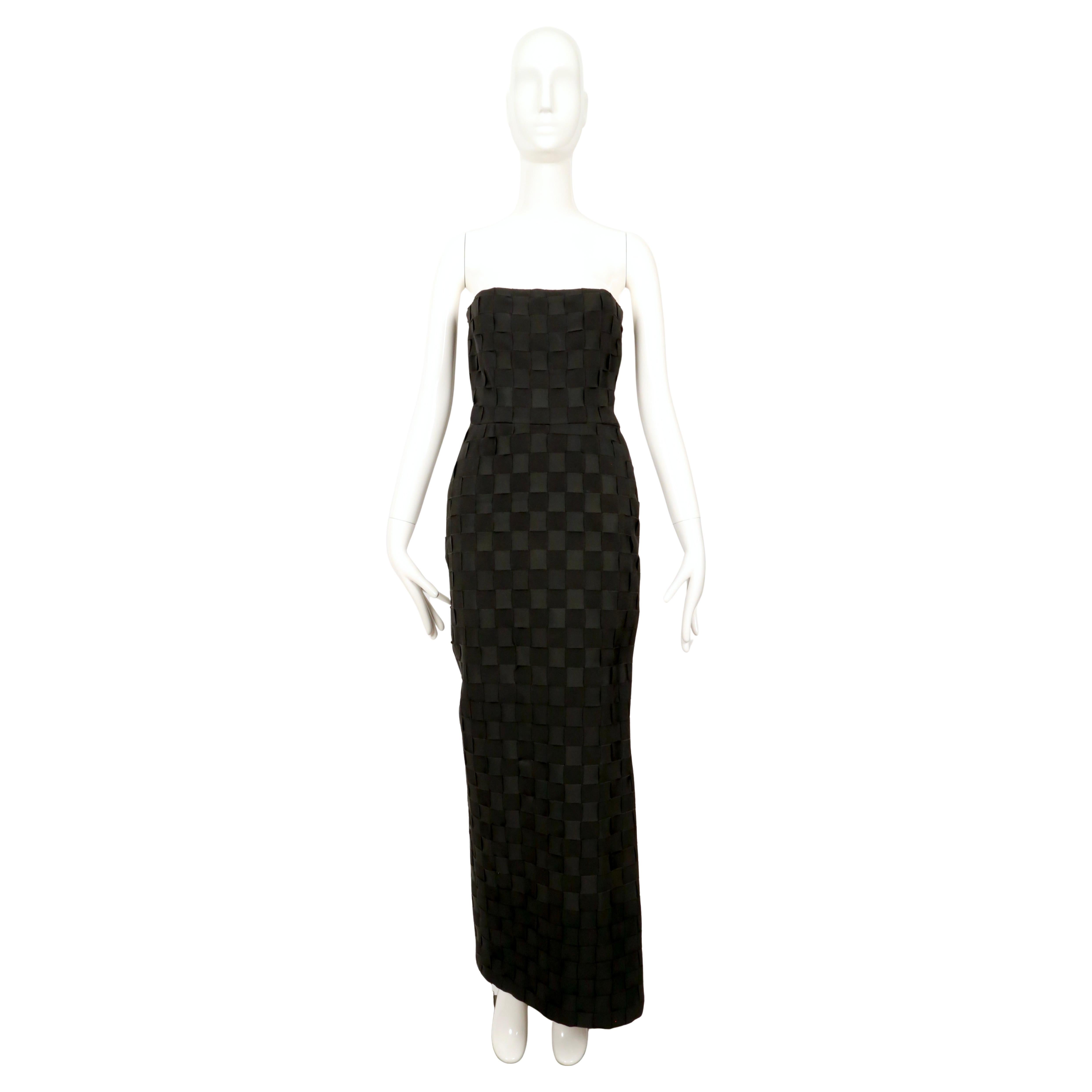 Stunning, black woven grosgrain ribbon strapless dress with cut out at left leg designed by Gianni Versace for the Gianni Versace Couture label dating to the early 1990's. Best fits a US 2-4. Approximate measurements: bust 32