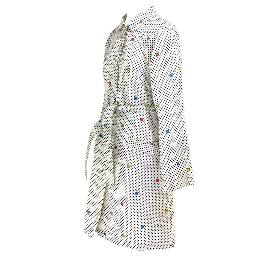 Presenting a unique early 1990s polka dot and Medusa trench coat, designed by Gianni Versace. This coat takes a fun, almost pop art approach, to the average trench coat with polka dots and Medusas in primary colors covering every part of the coat.