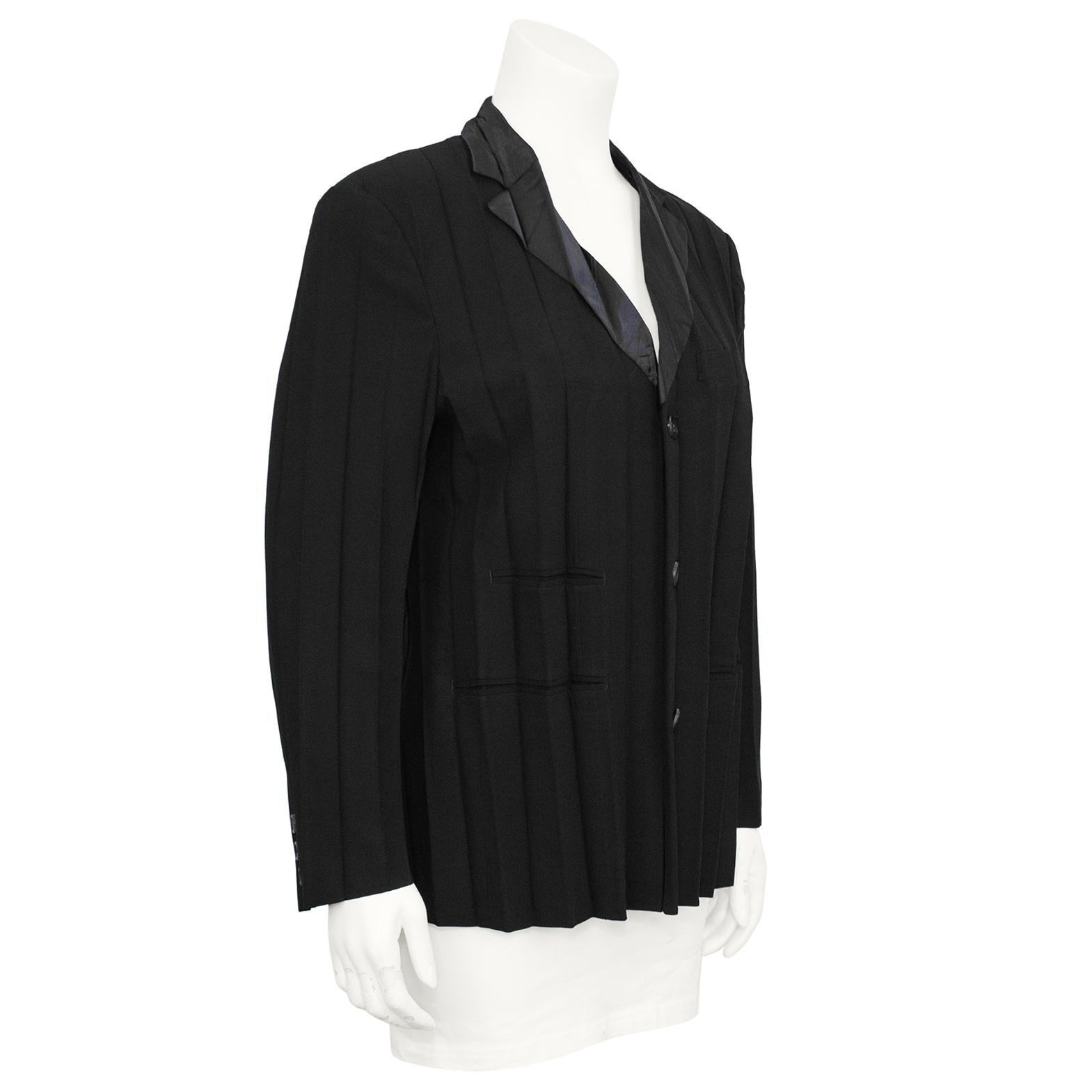 Early 1990s Issey Miyake black pleated blazer with 3 button closure. The jacket is made of polyester which holds the wide pleated detail throughout. Three welt pockets on the front of the jacket and a notched collar.  In excellent condition, marked