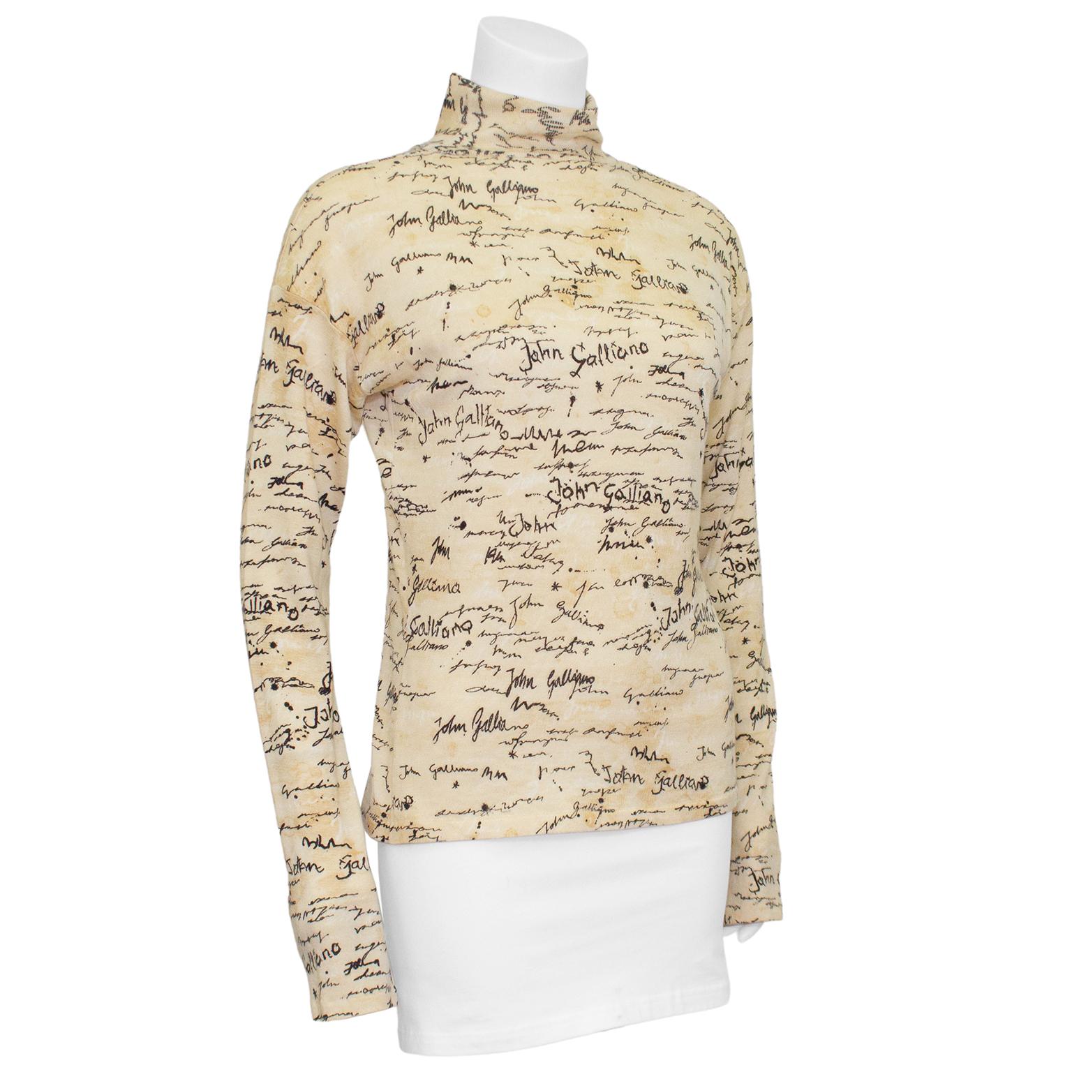 John Gallino turtleneck from the earlt 1990s. Fabric has been designed to look like tea soaked old scripts with John Galliano printed all over in different types of hand writing. Slightly elongated sleeves. Ribbed at neck with unfinished hem that
