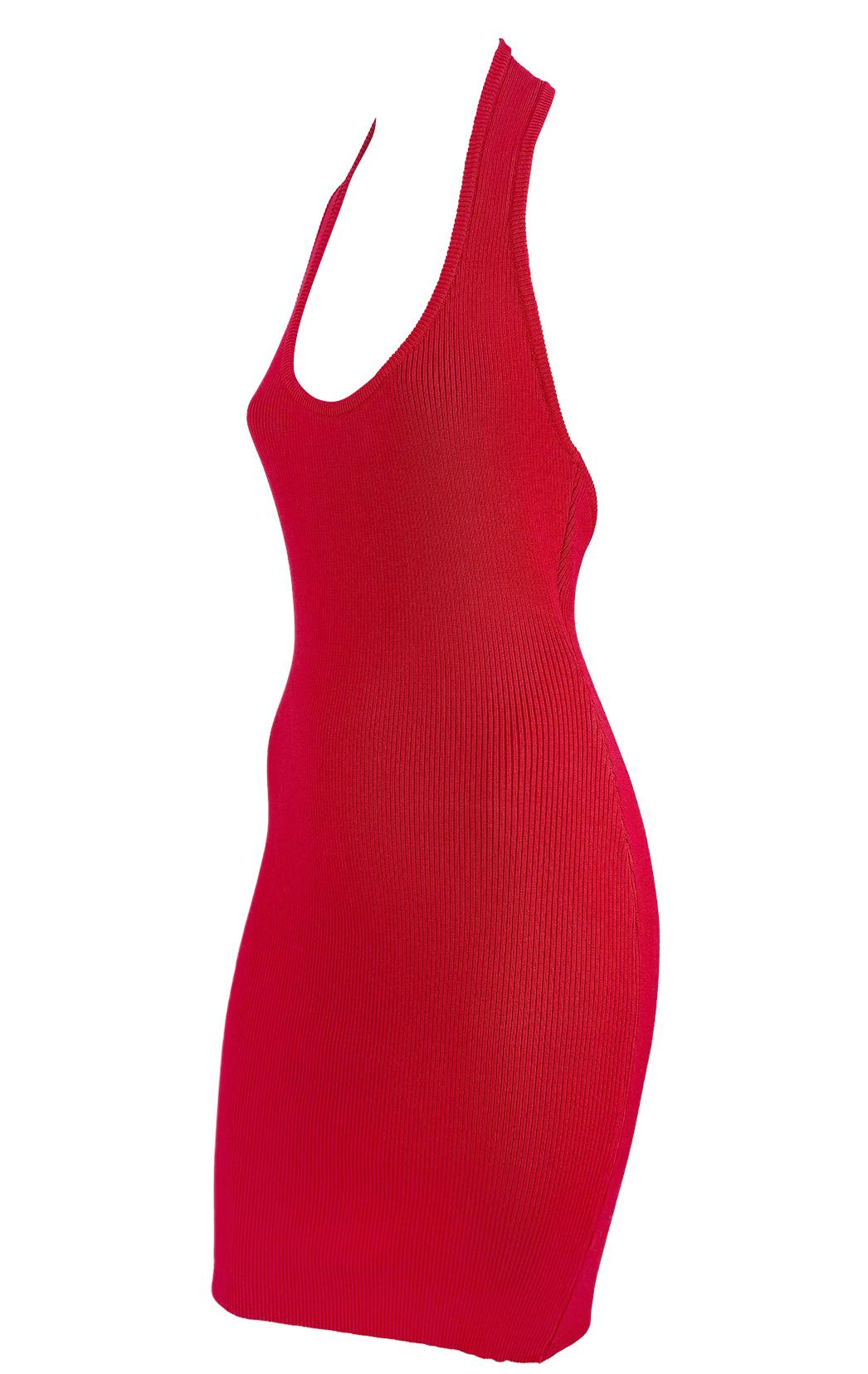This body-hugging halter dress was designed by Michael Kors for his mainline in the early 1990's. It is crafted from a cotton blend in a ribbed knit with a bodycon fit. The minimalist silhouette features a plunging scoop neckline and open back.