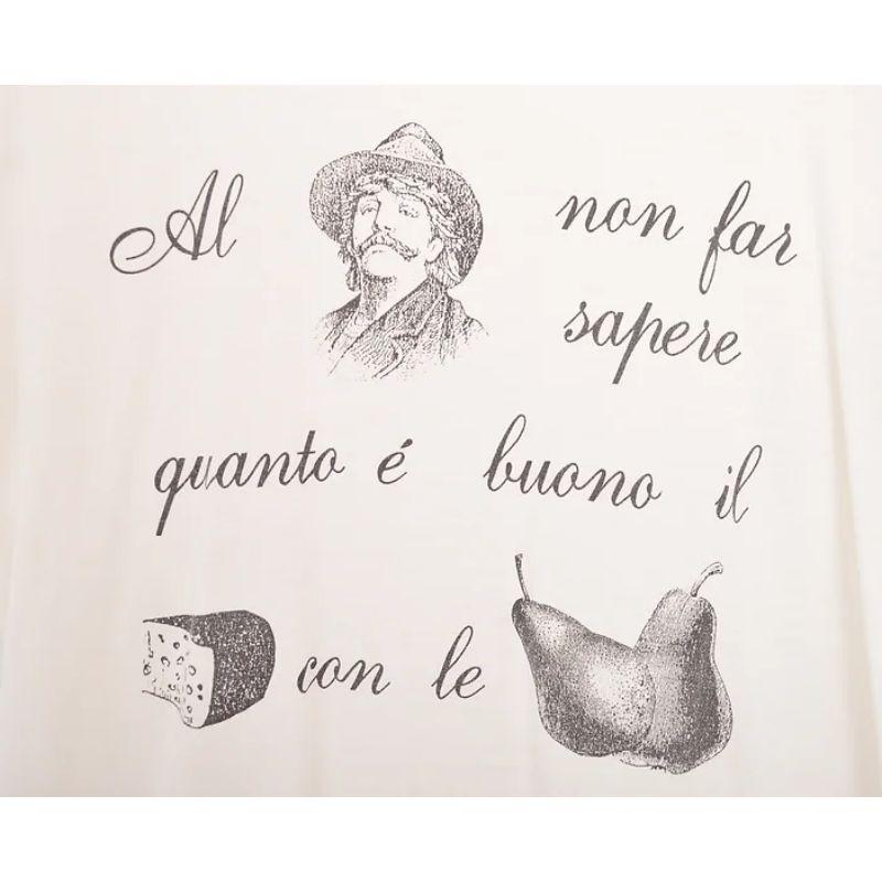 Vintage 1990s Moschino T-shirt, depicting the famous Italian saying 'al contadino non far sapere quanto e bueno il formaggi con le pera', in English: 'Don't tell the farmer how good pears are with cheese', implying that he'll never part with them