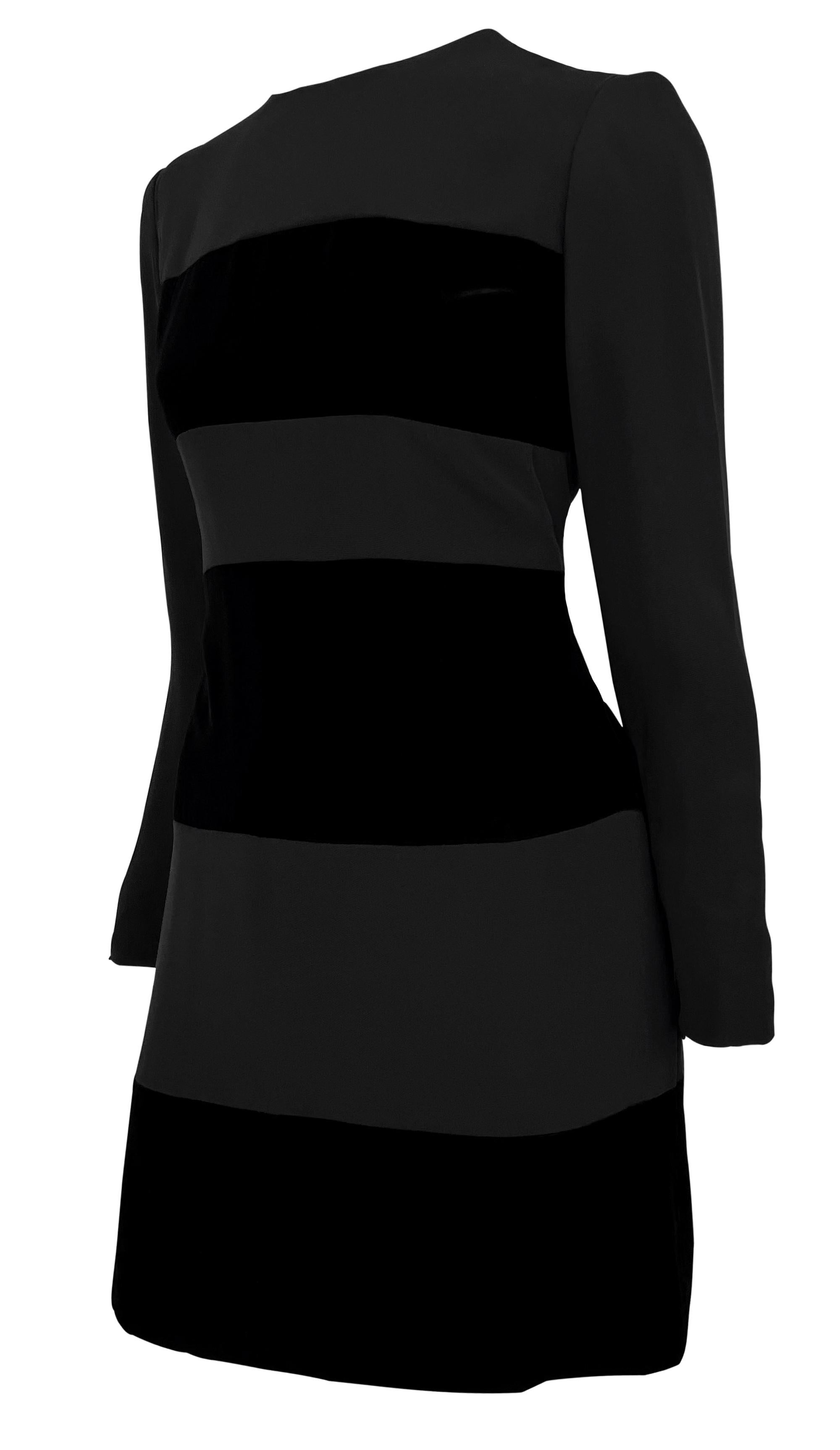 This Oscar de la Renta dress from the 1990s features a sophisticated design with alternating black velvet and matte fabric panels. The dress has a long-sleeved, fitted silhouette with a round neckline and a back zipper closure.

Approximate