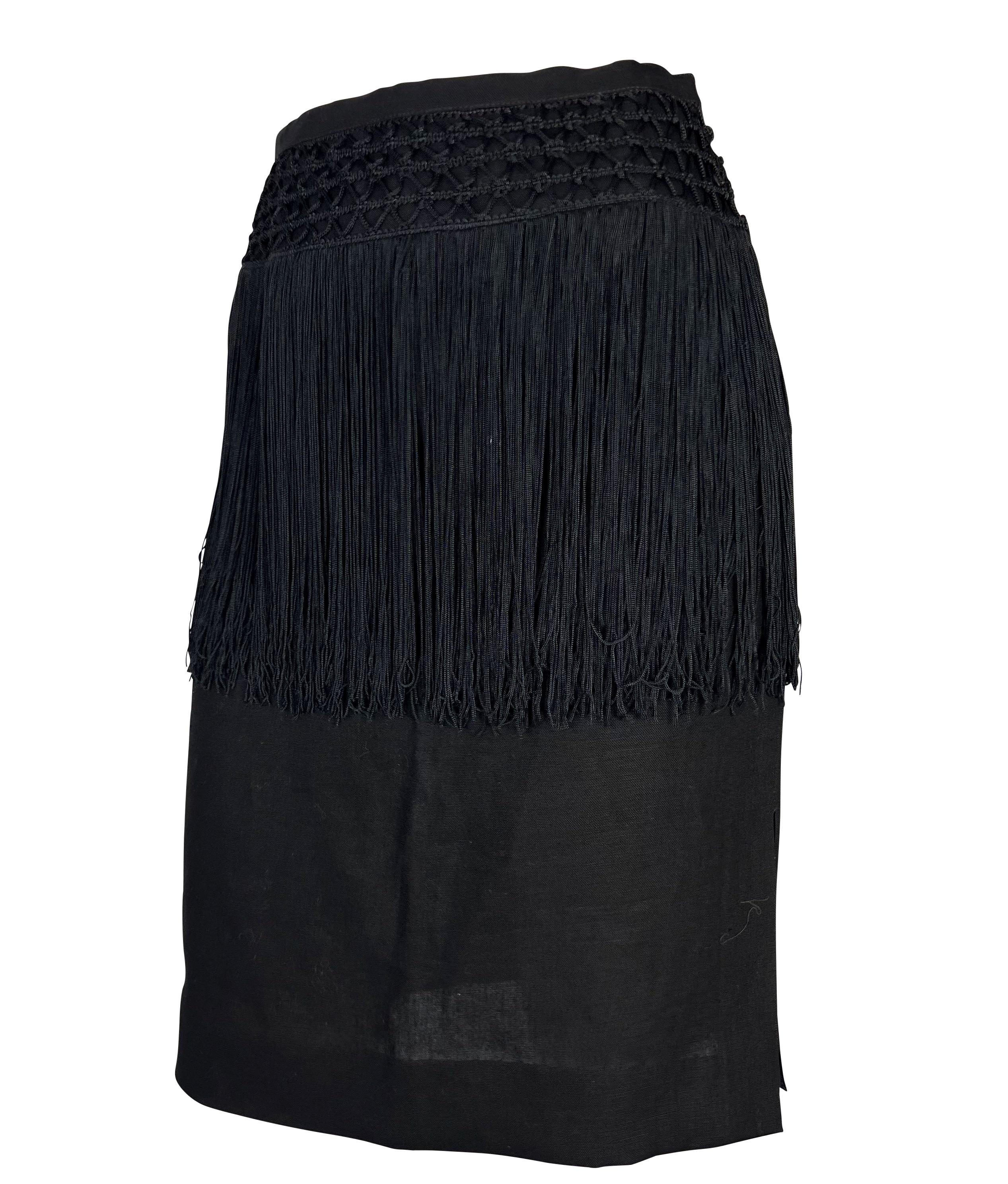 Presenting a black fringe-trimmed skirt designed by Valentino Garavani in the late 1980s or early 1990s. This piece is constructed in light, semi-sheer linen with a knit accent at the waist. Long fringe trim beautifully captures movement. Check out