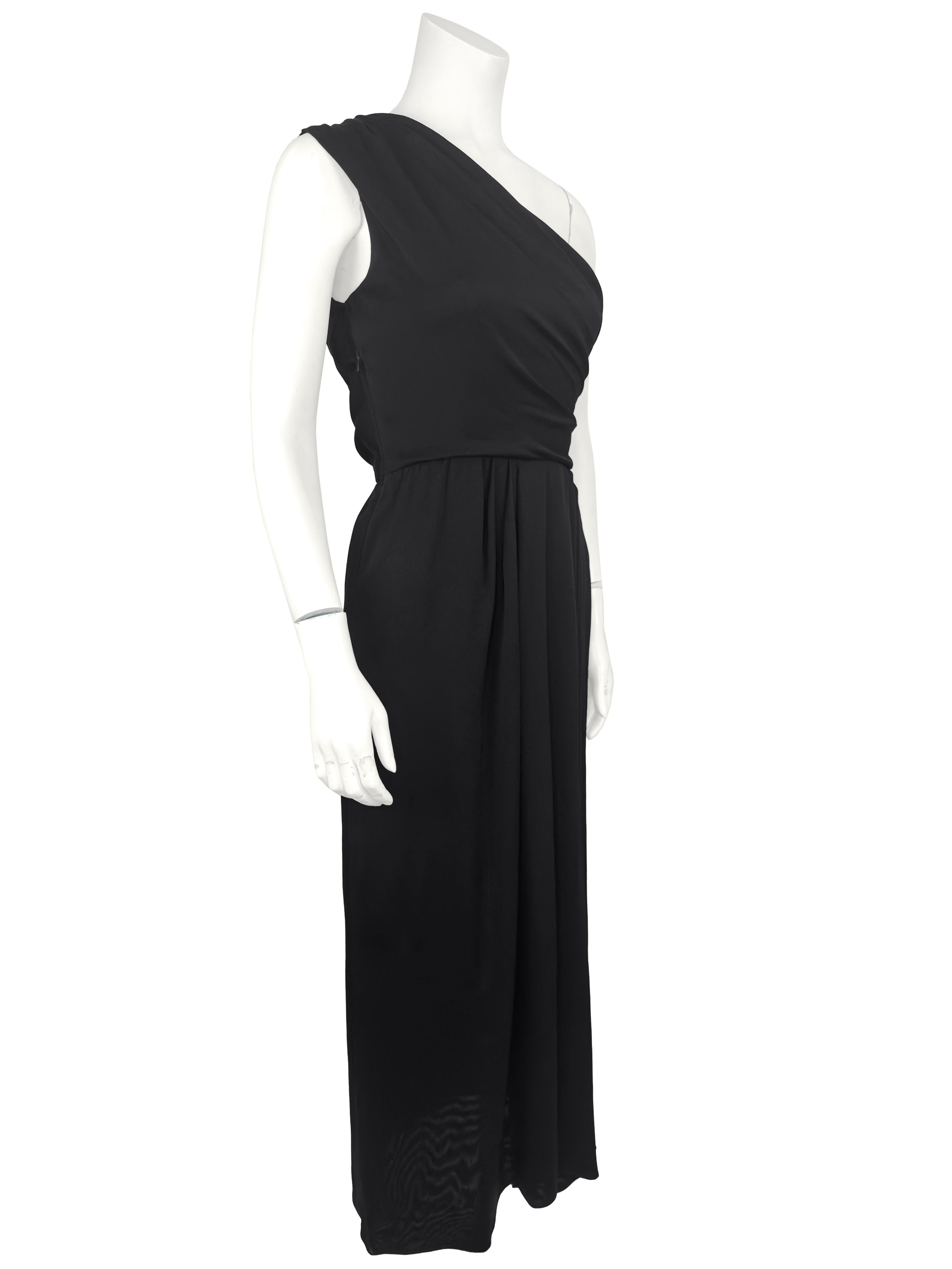 Early 1990s YSL Yves Saint Laurent black jersey one shoulder evening gown. The top of the gown is gathered from the top of the right shoulder to the opposite side. Zips up the left side and secured with a hook. The skirt of the dress is unlined and