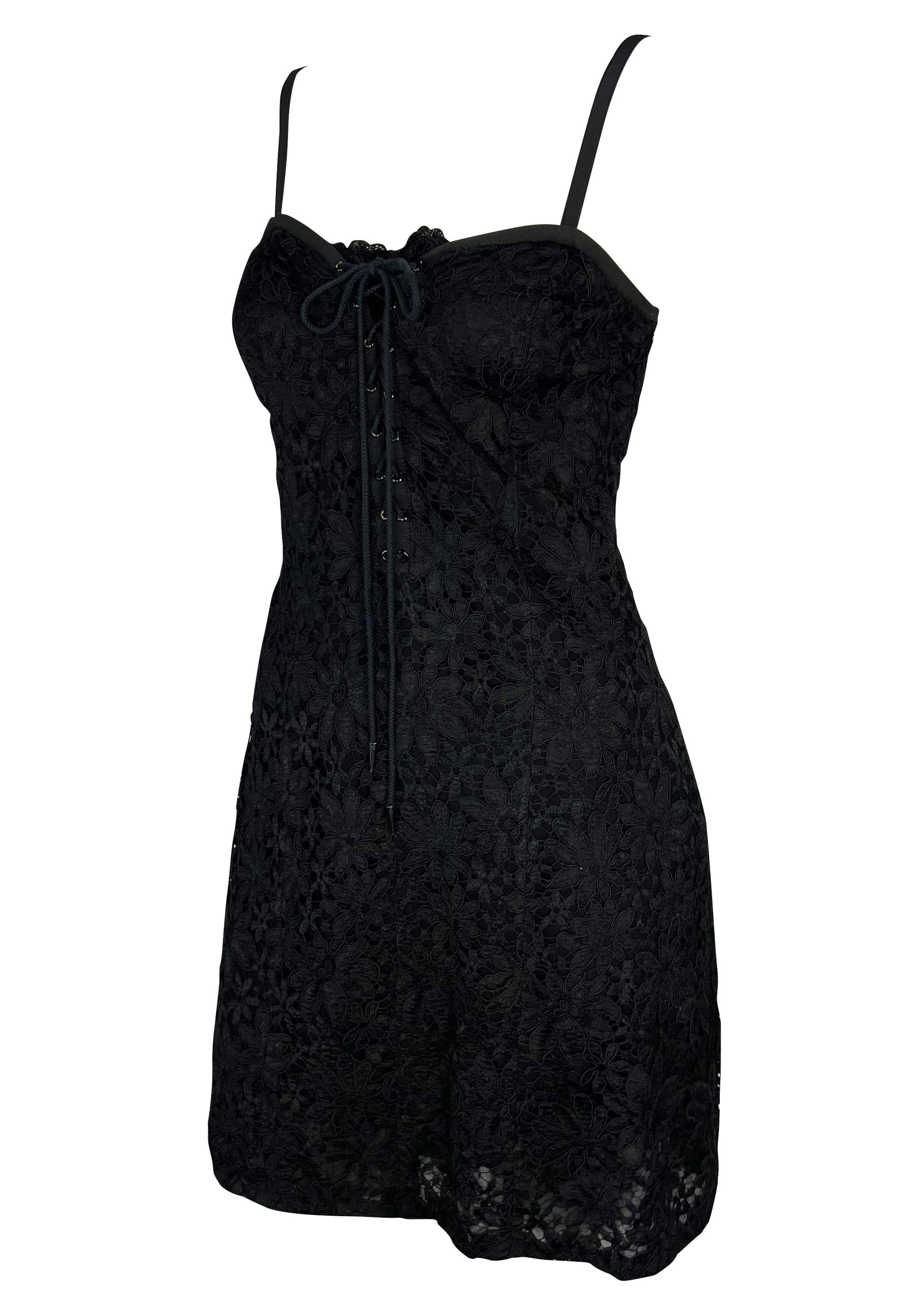 Presenting a black lace Yves Saint Laurent Rive Gauche mini dress. From the early 1990s, this beautiful dress is covered in lace and features a sweetheart-style neckline with spaghetti straps and a plunging lace-up detail at the front. Effortlessly