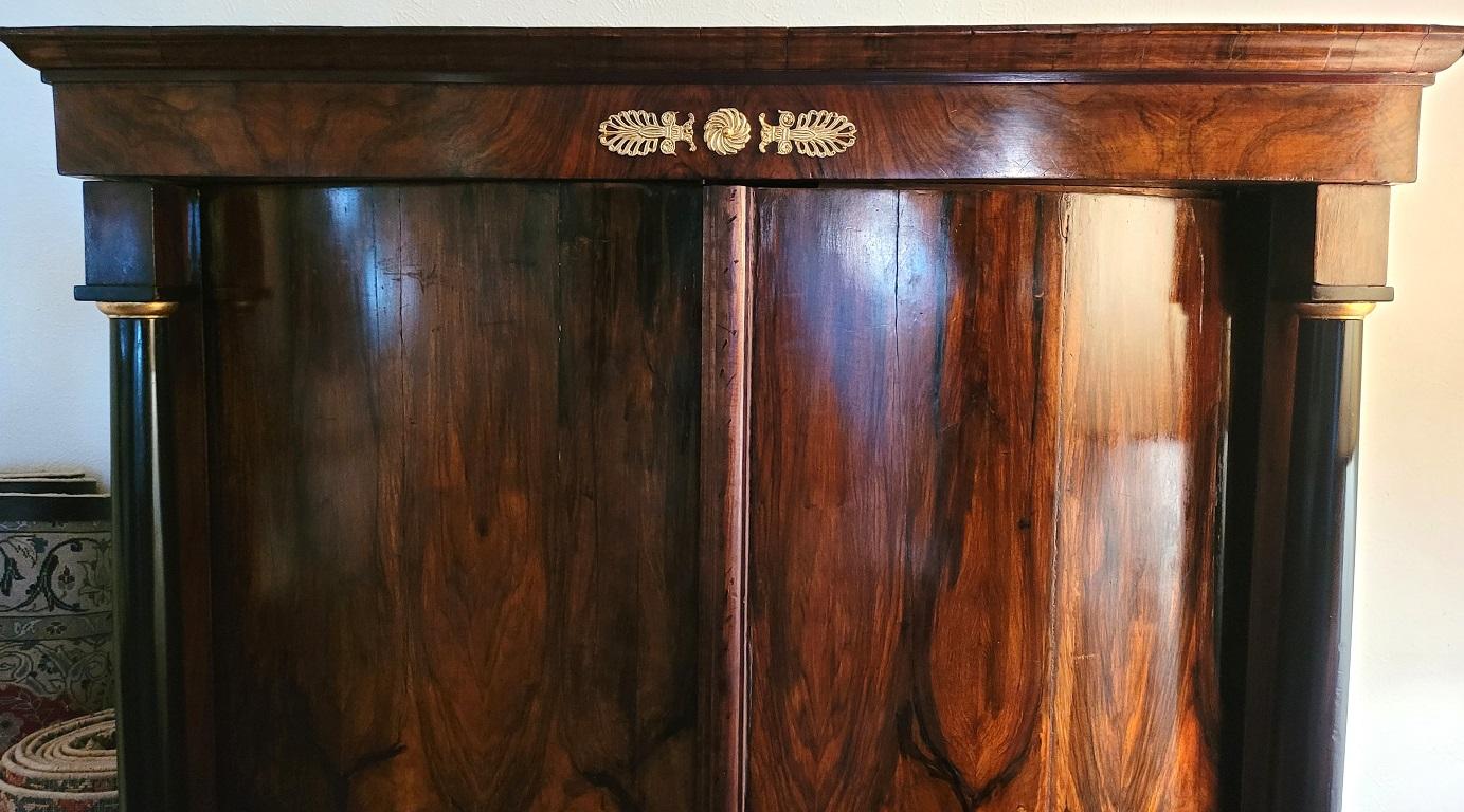Presenting a simply gorgeous early 19 C French empire armoire wine cabinet.

This is an early 19th Century, French empire style or Napoleon I, Armoire made with the most stunning butterflied burl Walnut veneers, which we have converted into a wine
