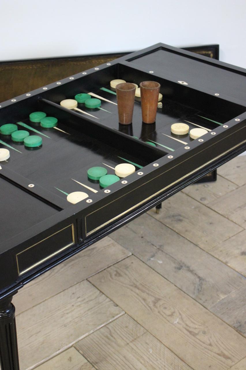 An early 19th century French Tric Trac games table ( Backgammon ) in the Louis XVI taste, later ebonized retaining the original counters. 

France 

Measurements: 61cm high (knee height).