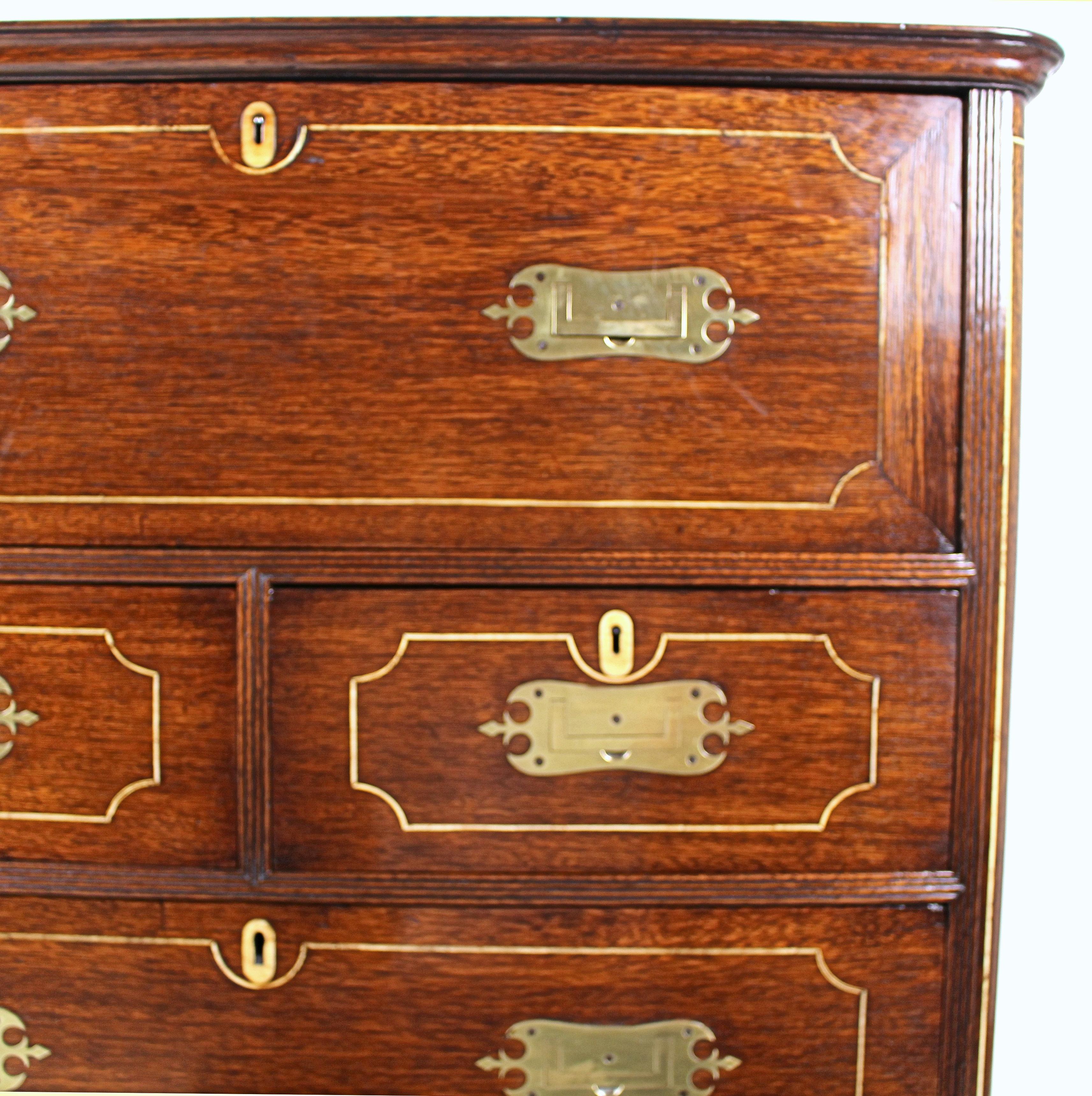 This very attractive and well-designed early 19th century. Anglo Chinese Padouk secretaire chest of drawers features a bone line inlay and decorative shaped brass handles. The fall front panel reveals a fitted interior with drawers and cupboards