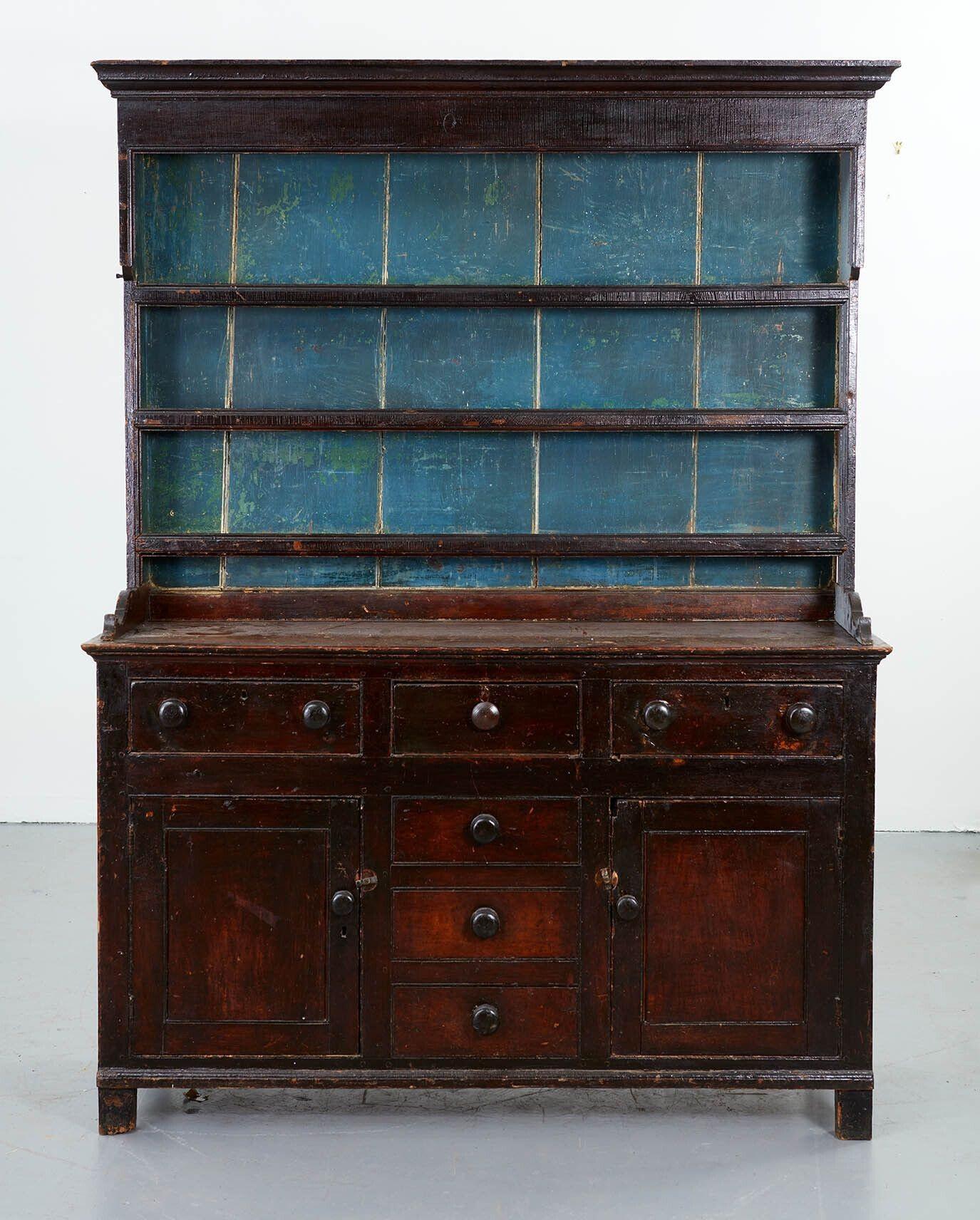A very fine early 19th century English country dresser with cupboard and drawered base on stile legs and corniced rack above, supported on shaped brackets and still retaining original duck egg blue paint on interior of shelves and original scumble