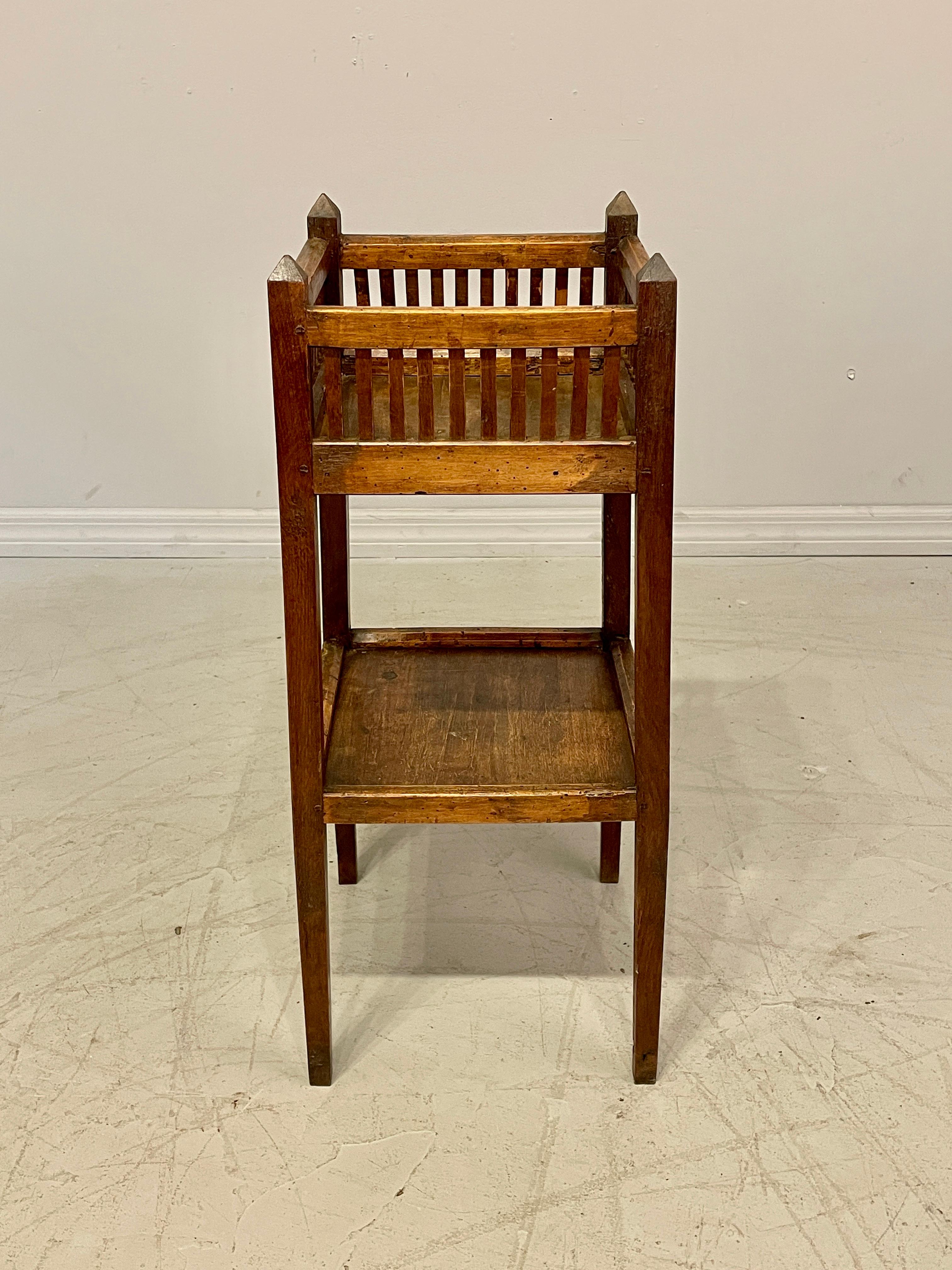 An early 19th century French Provincial two tiers side table made of oak and beechwood. Pegged construction. Wax patina. No restoration. Unusual country table with all the charms of an old used table. Dimensions are 12