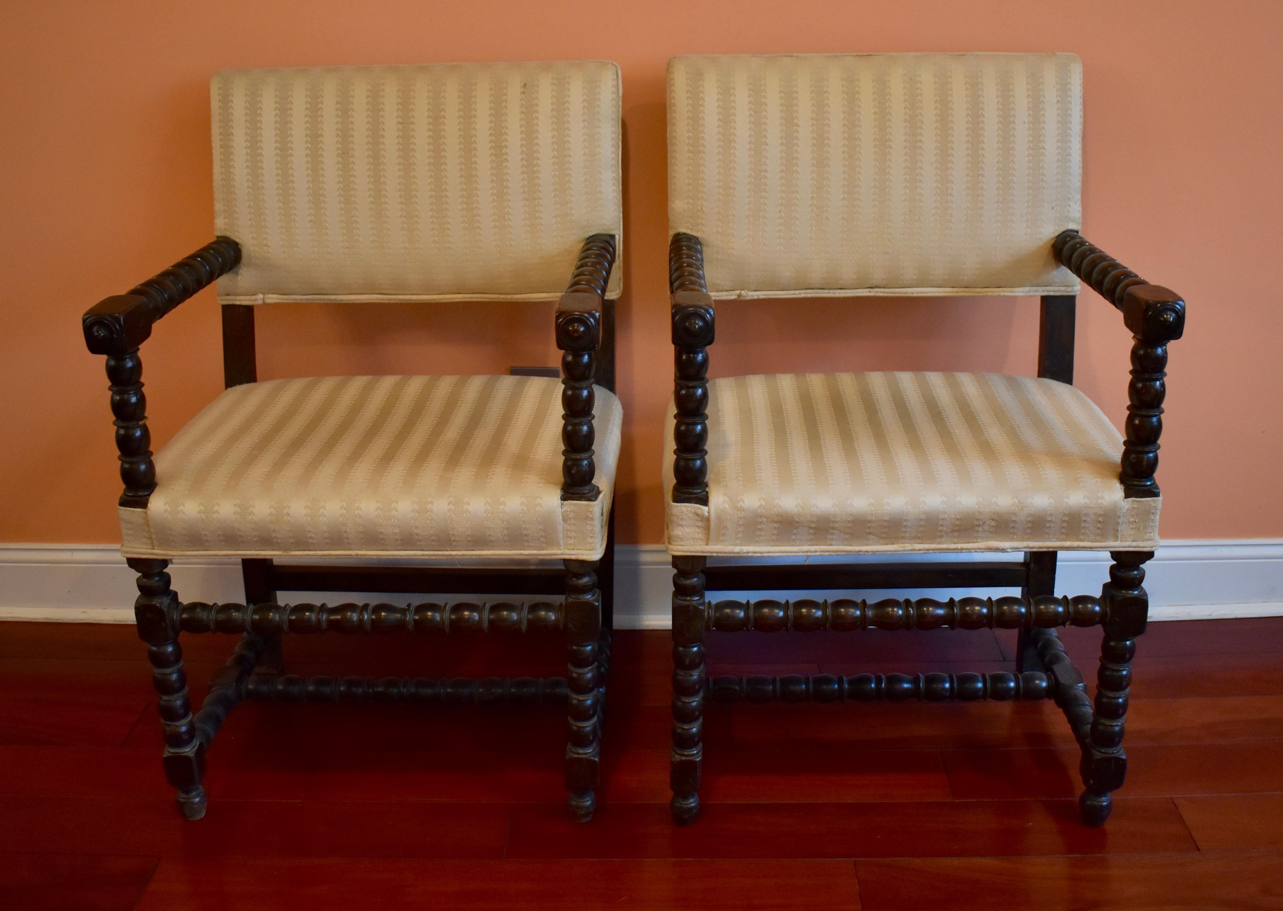 A rare pair of early 19th century New York, turned wood side chairs, in the Dutch Colonial style. Constructed of an ebonized wood, and styled with spindle turned arms and supports, terminating in spindle turned legs and stretchers. 

Heavy, sturdy