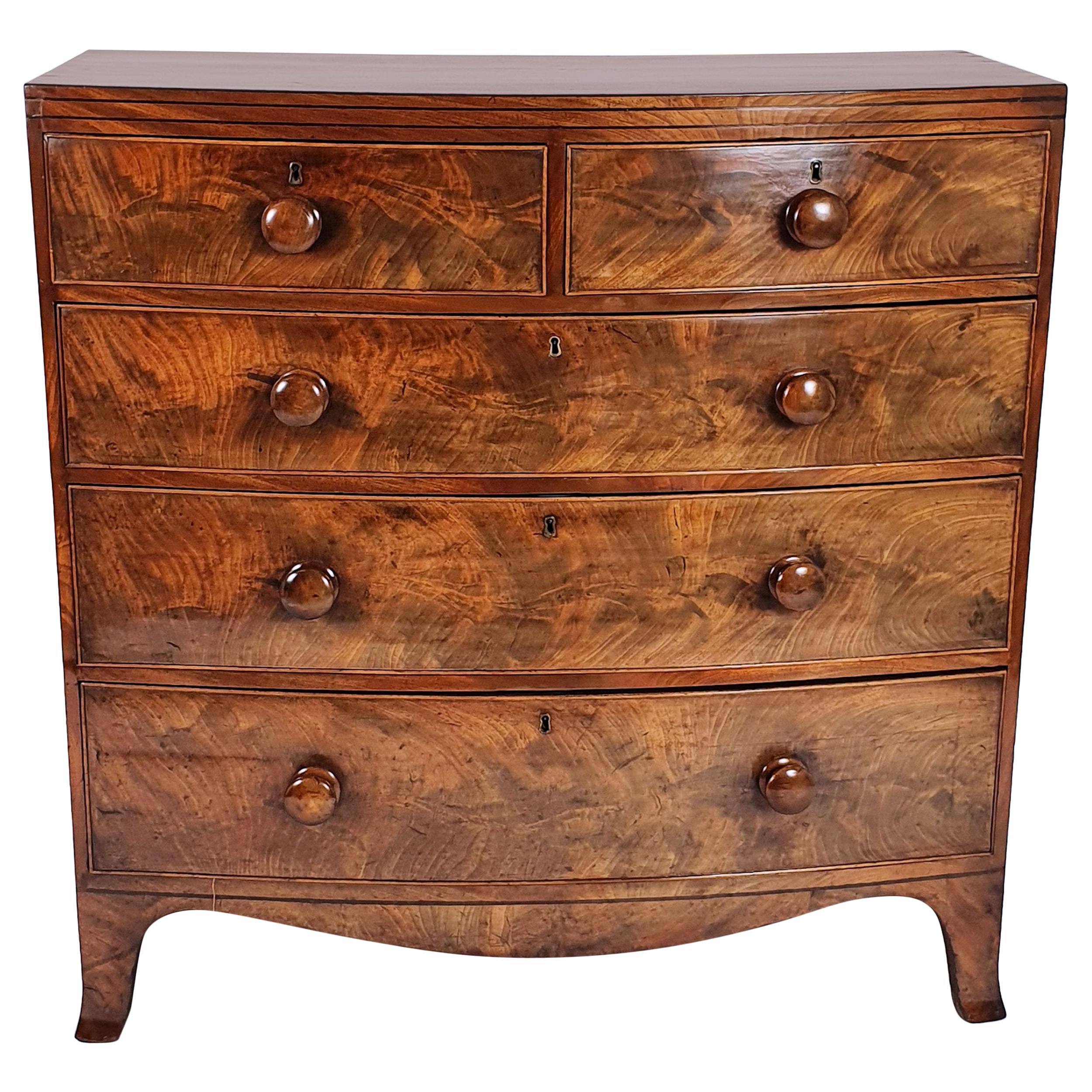 Early 19th Century English Flame Mahogany Bow Fronted Chest of Drawers